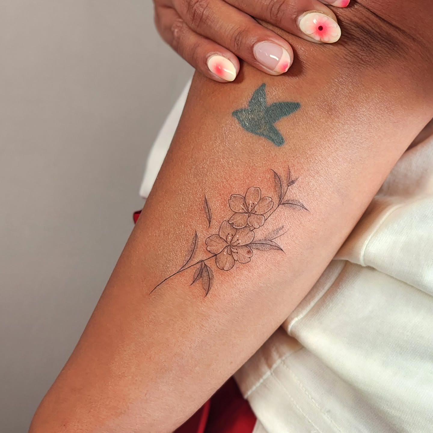 Cherry blossoms black and grey tattoo on the forearm by Tattoo artist - Luciana Dsilva, San Francisco, California