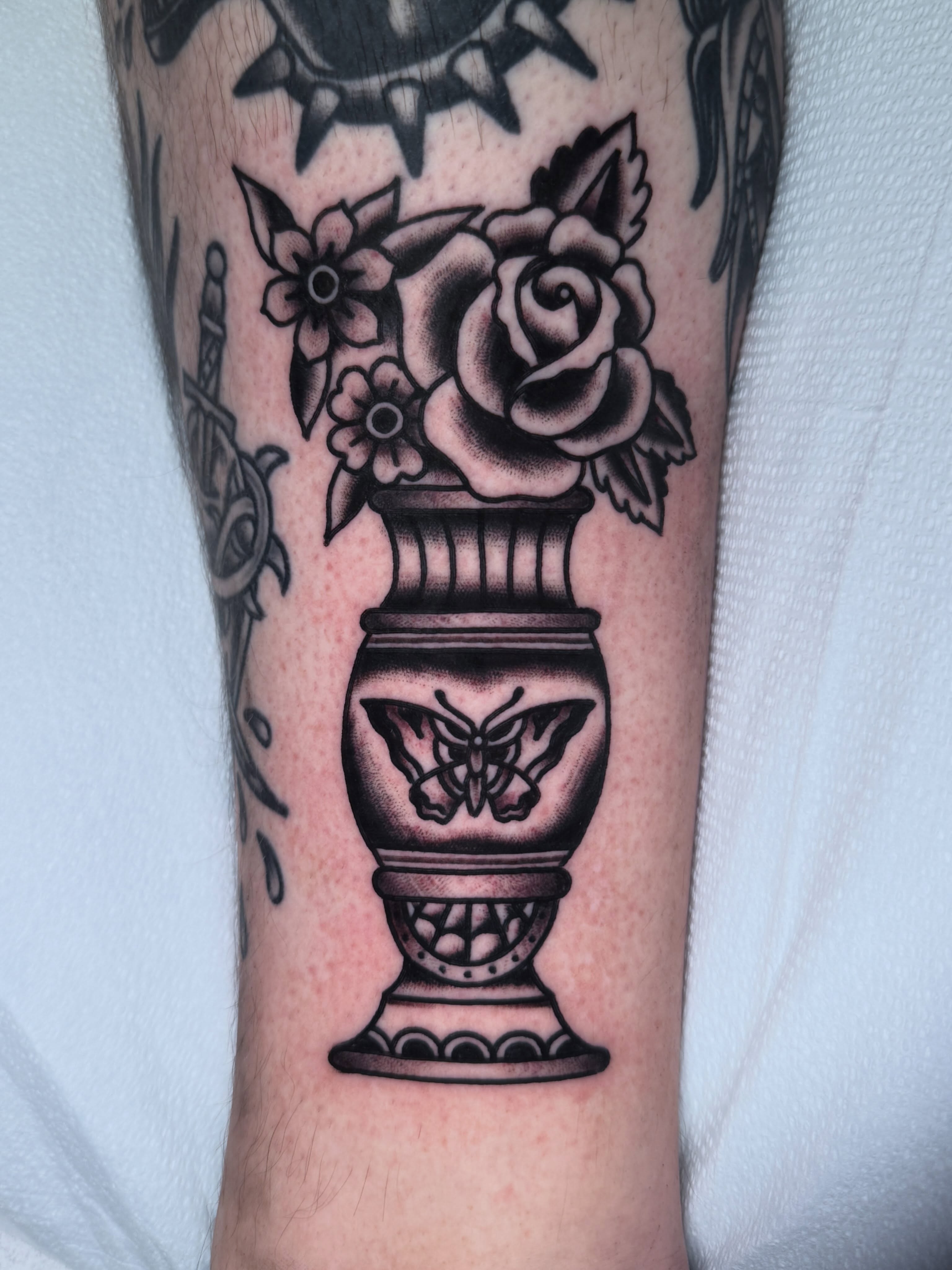 Vase with rose black and grey tattoo on the forearm by Ryan Moraski, Colorado Springs, Colorado