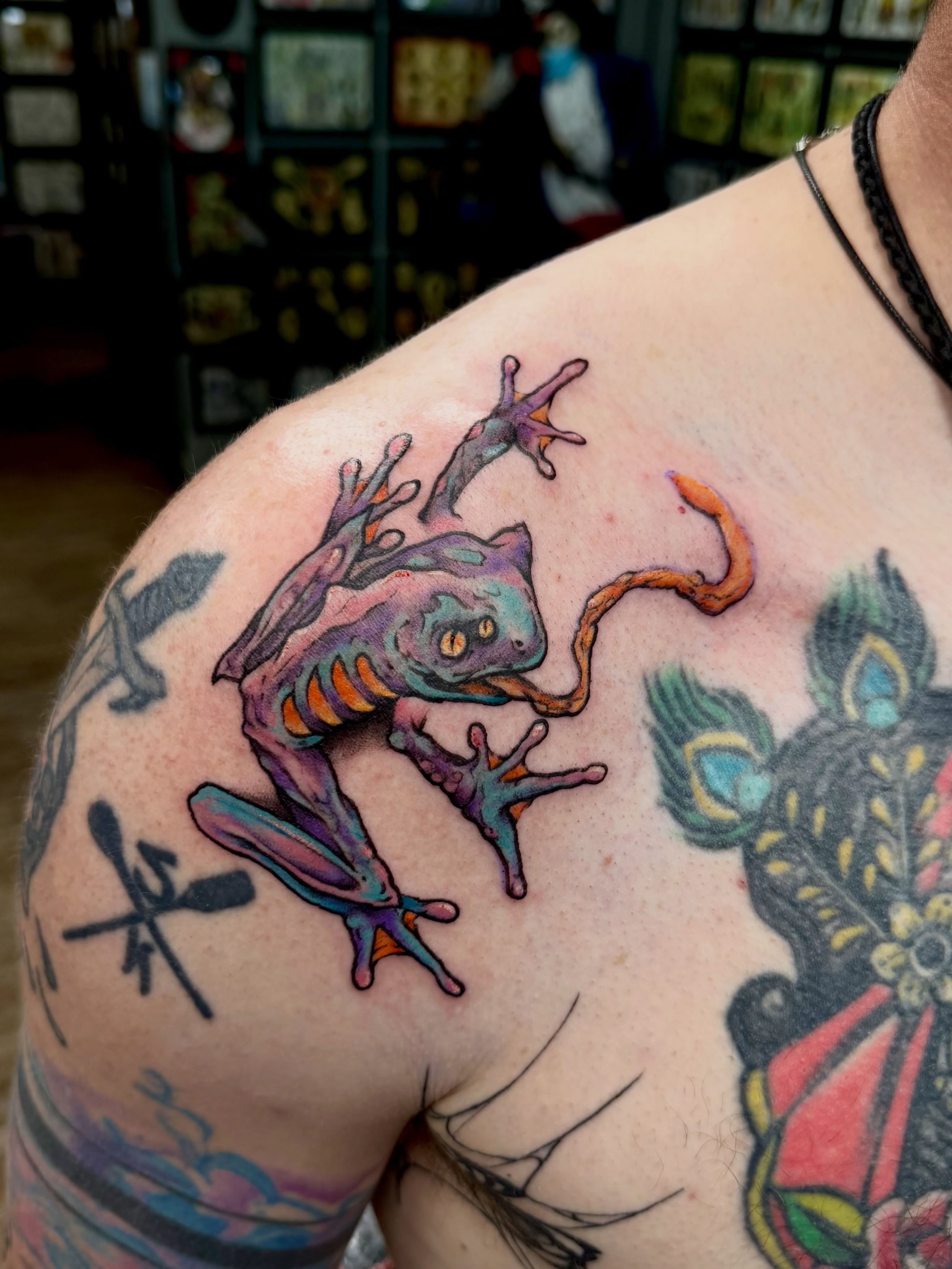 Frog new school tattoo on the shoulder by Josh Kronauer