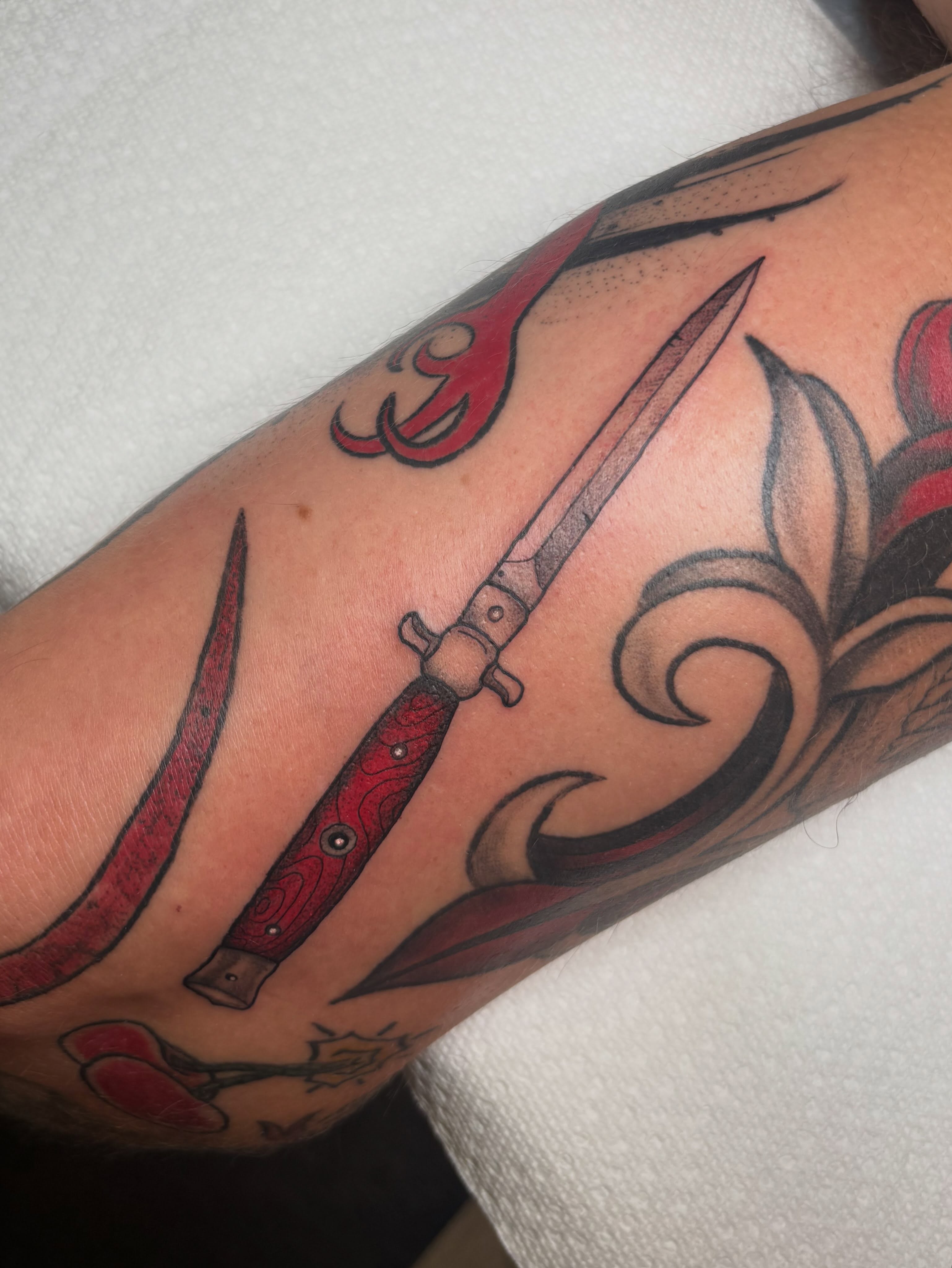 Knives and floral American traditional tattoo on the forearm by ππ‘ππ―π² πππ₯π₯ππ²