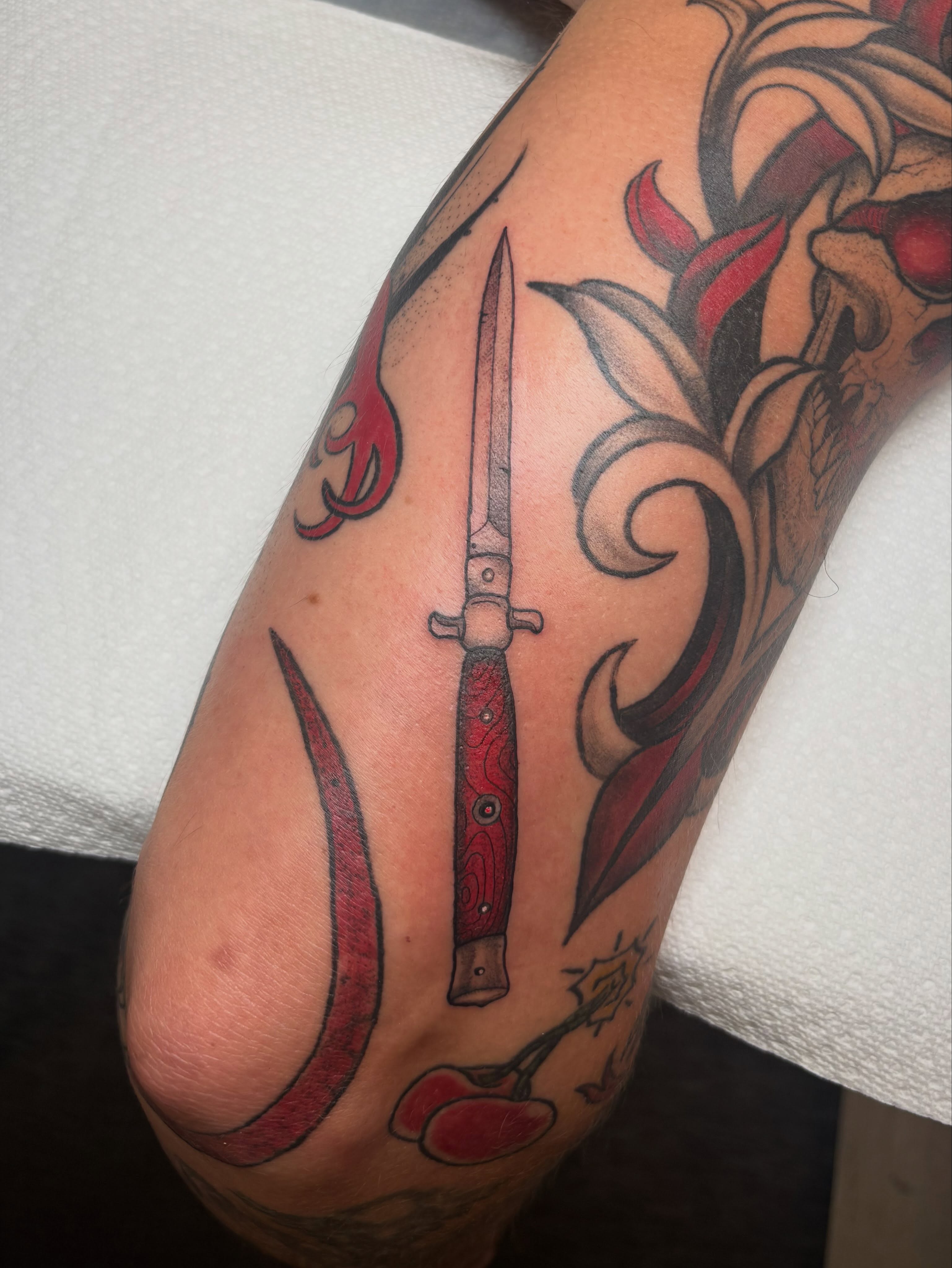Knife and floral American traditional tattoo on the forearm by ππ‘ππ―π² πππ₯π₯ππ²