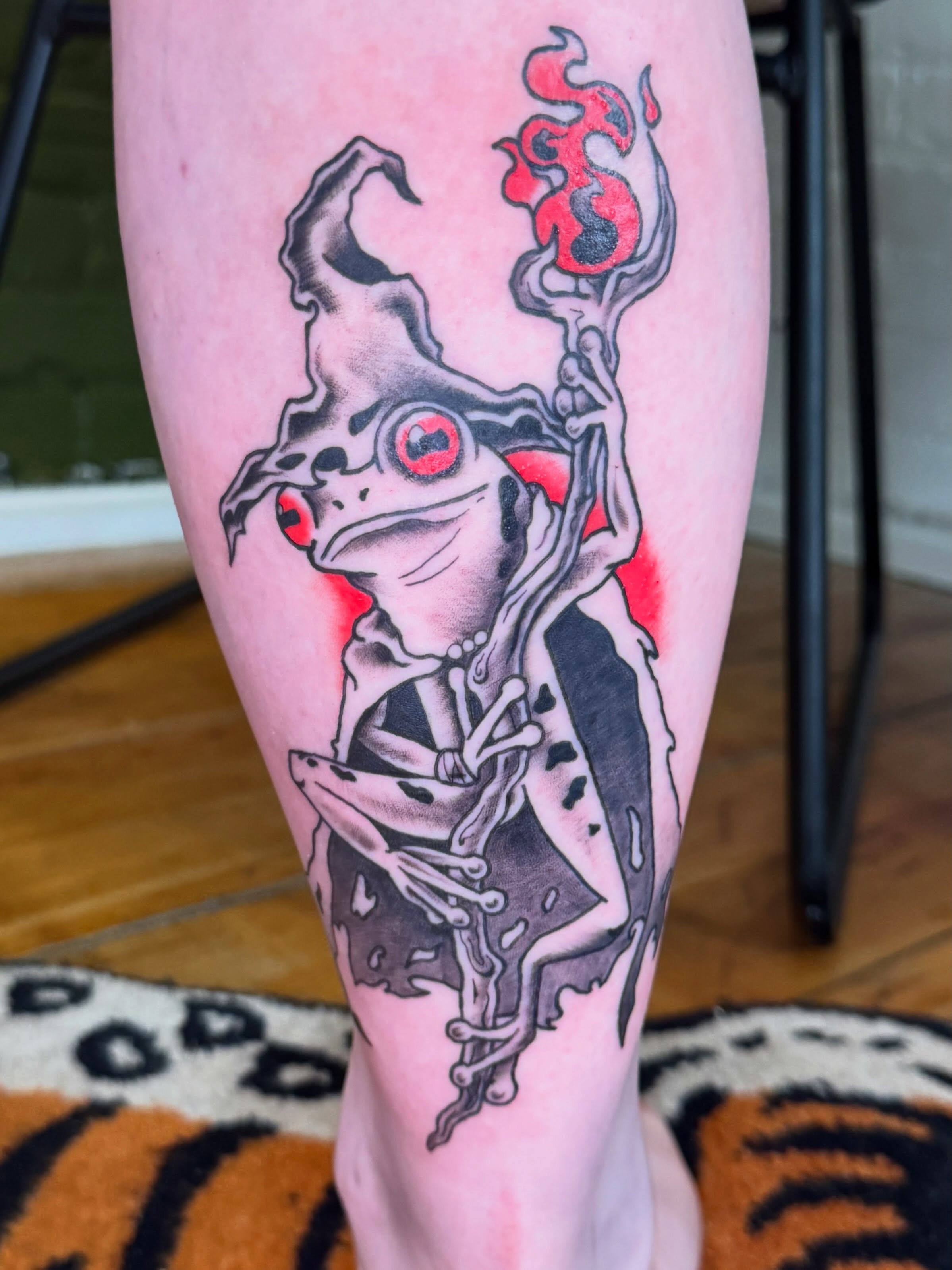Frog dark realism tattoo on the calf by Zac Smith-Chevalier