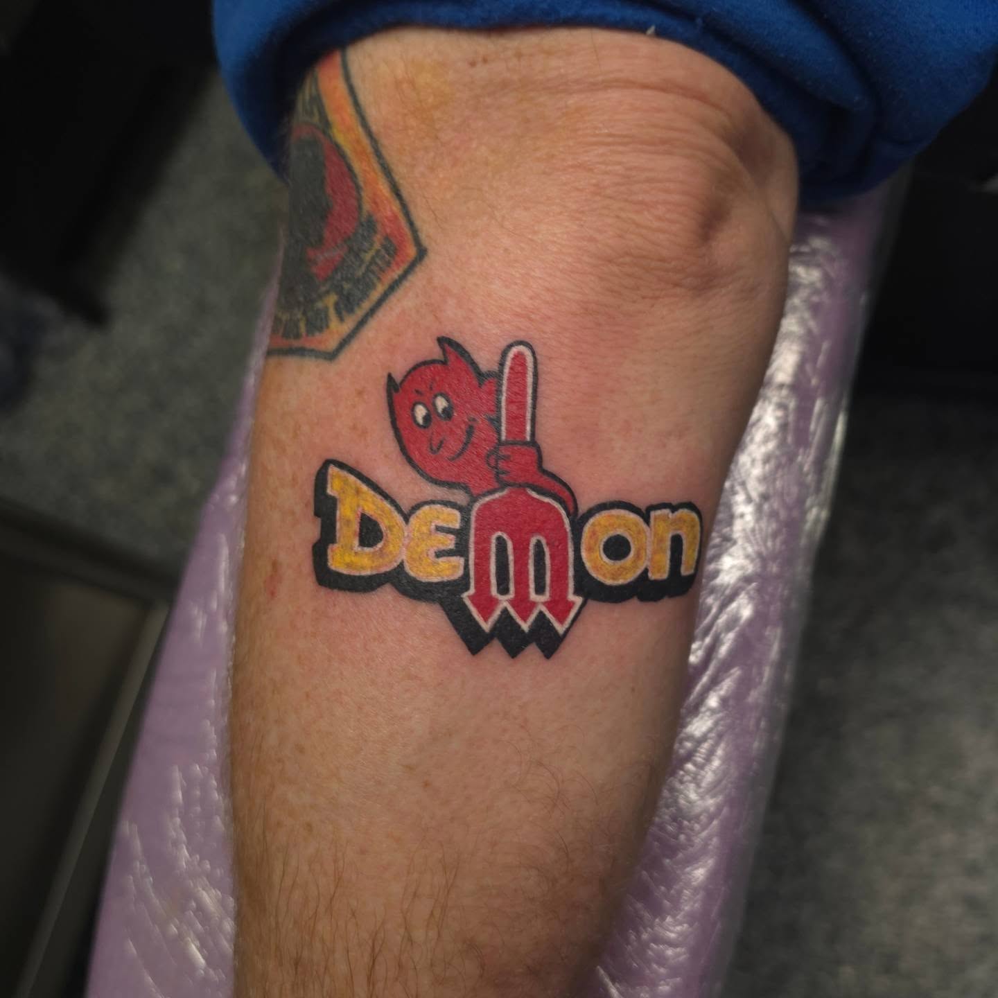 Demon new school tattoo on the forearm by xavia