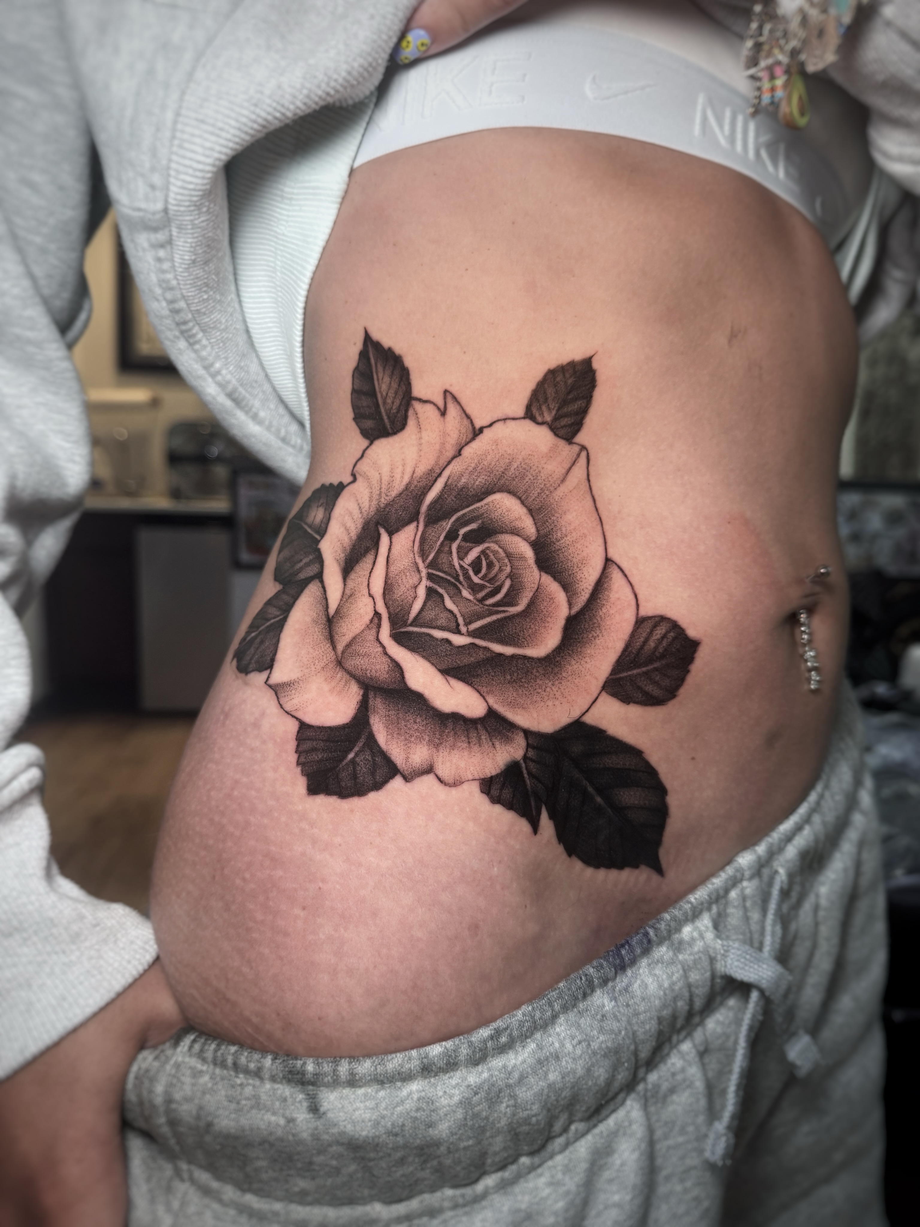 Rose black and grey tattoo on the ribs by David Gray
