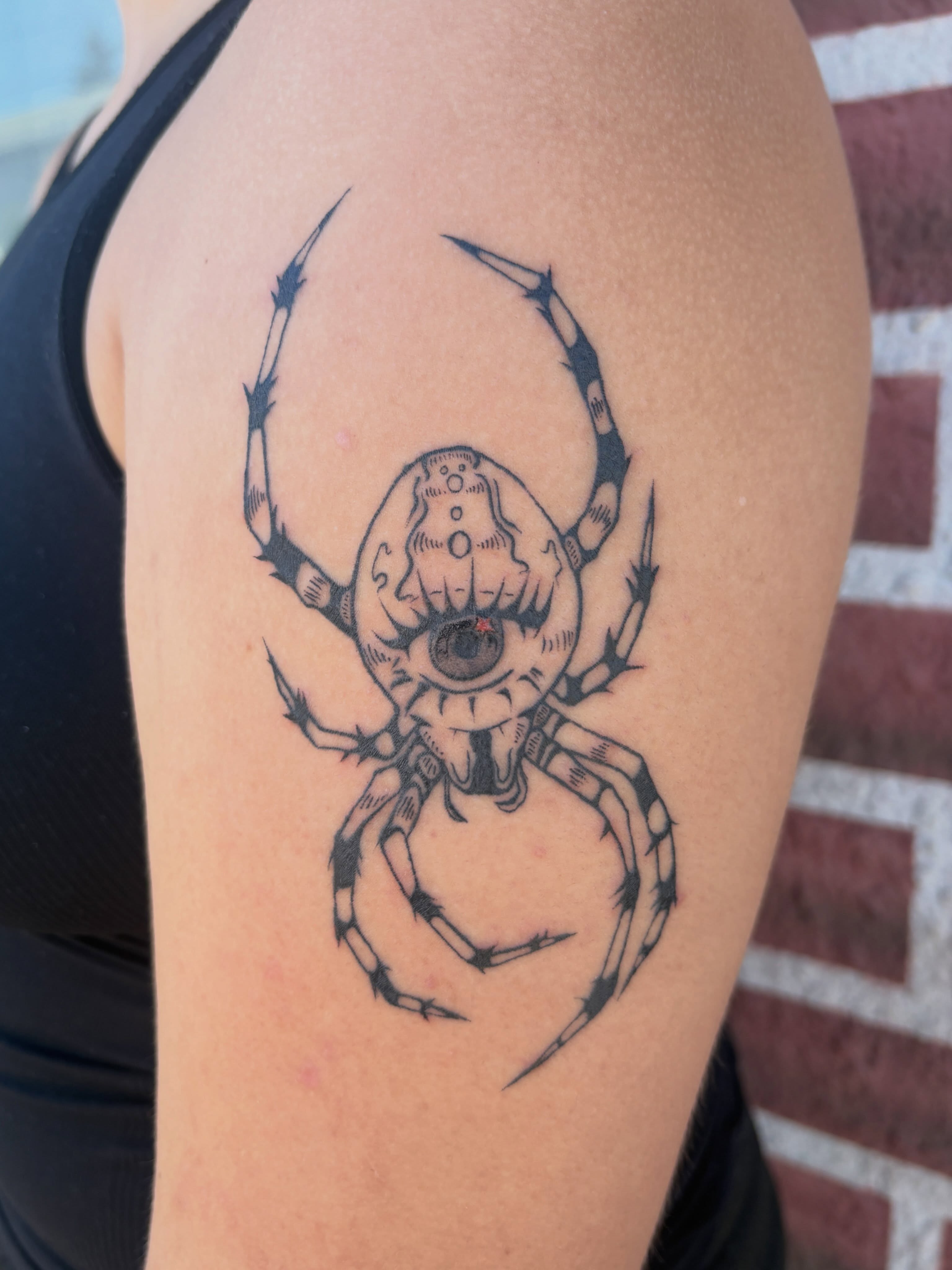 Spider geometric tattoo on the upper arm by izzy solae