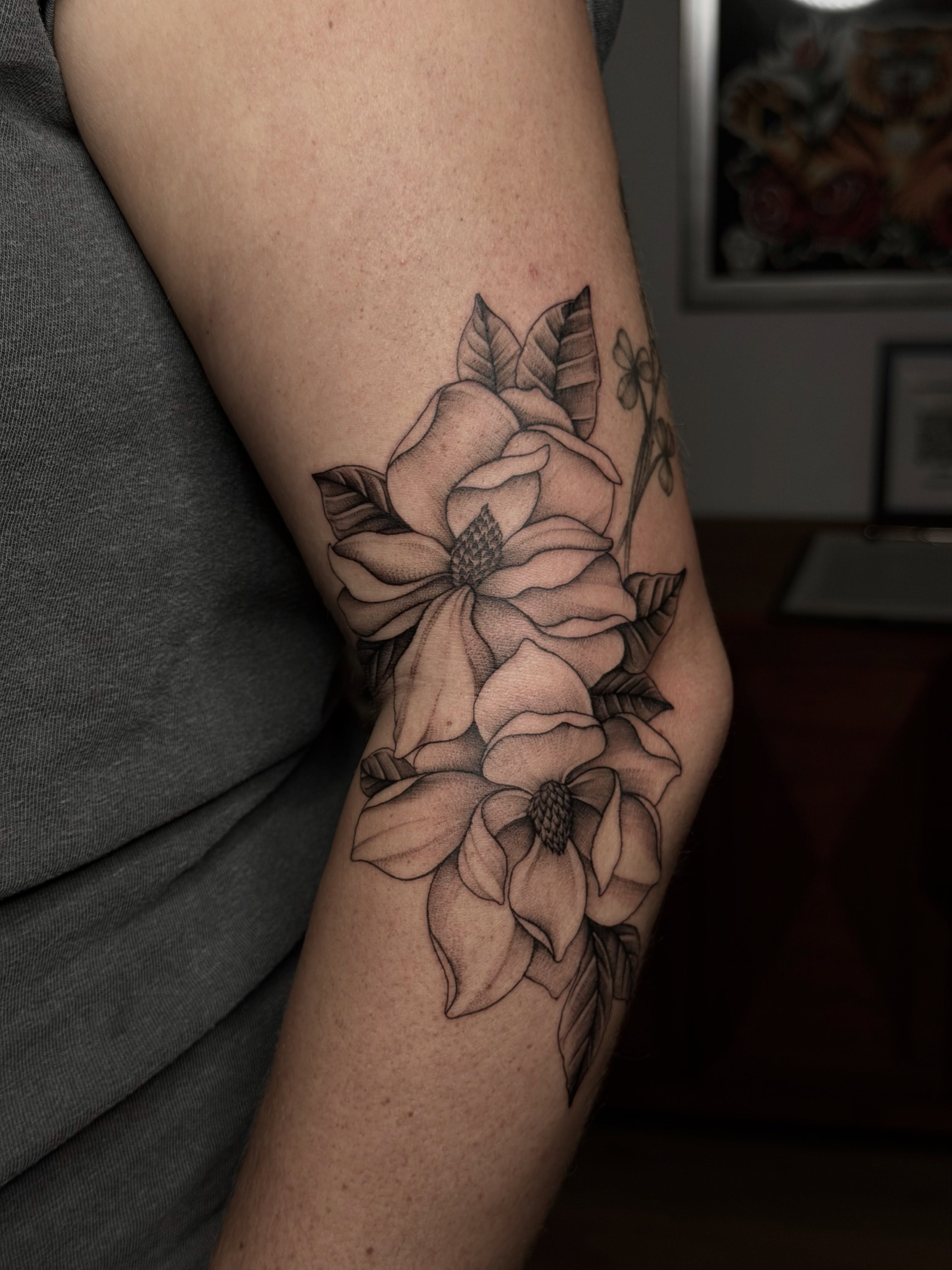 Flower bouquet black and grey tattoo on the forearm by Emma Cotter