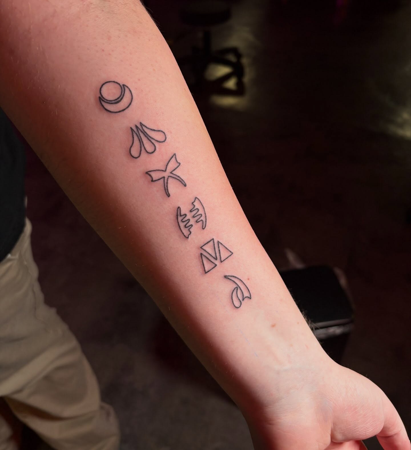Abstract symbols geometric tattoo on the forearm by Hailee Wallace Brussow