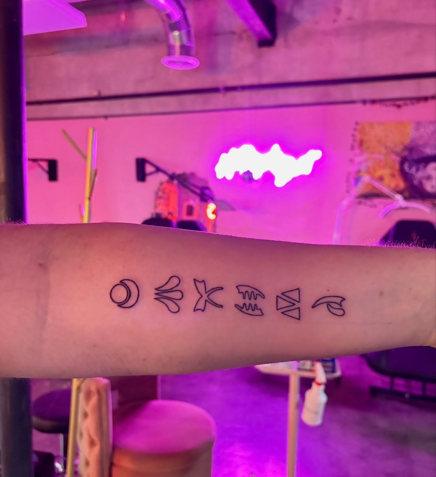 Zodiac symbols geometric tattoo on the forearm by Hailee Wallace Brussow