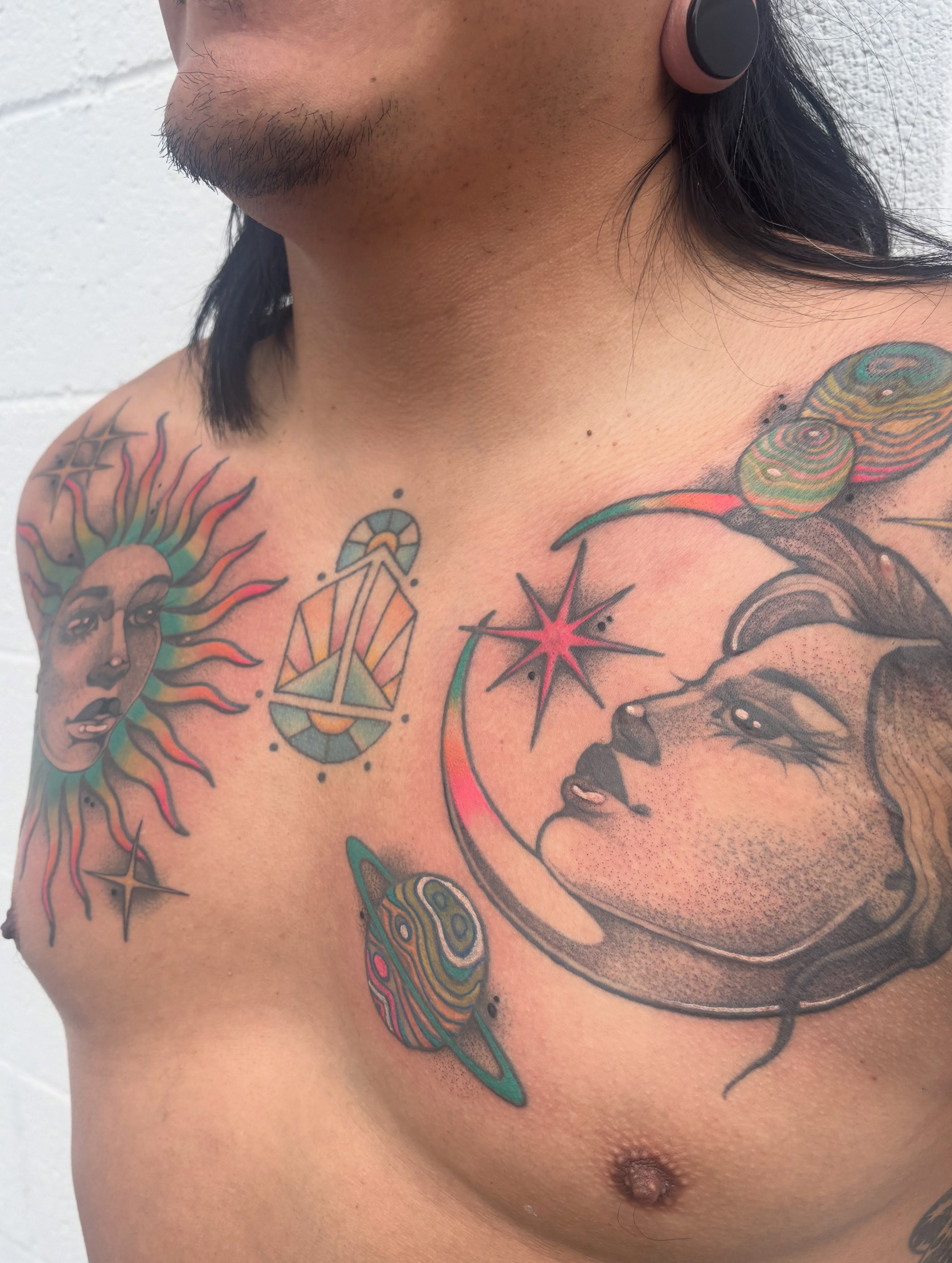 Astronomy-themed geometric tattoo on the chest by Carly Zehring