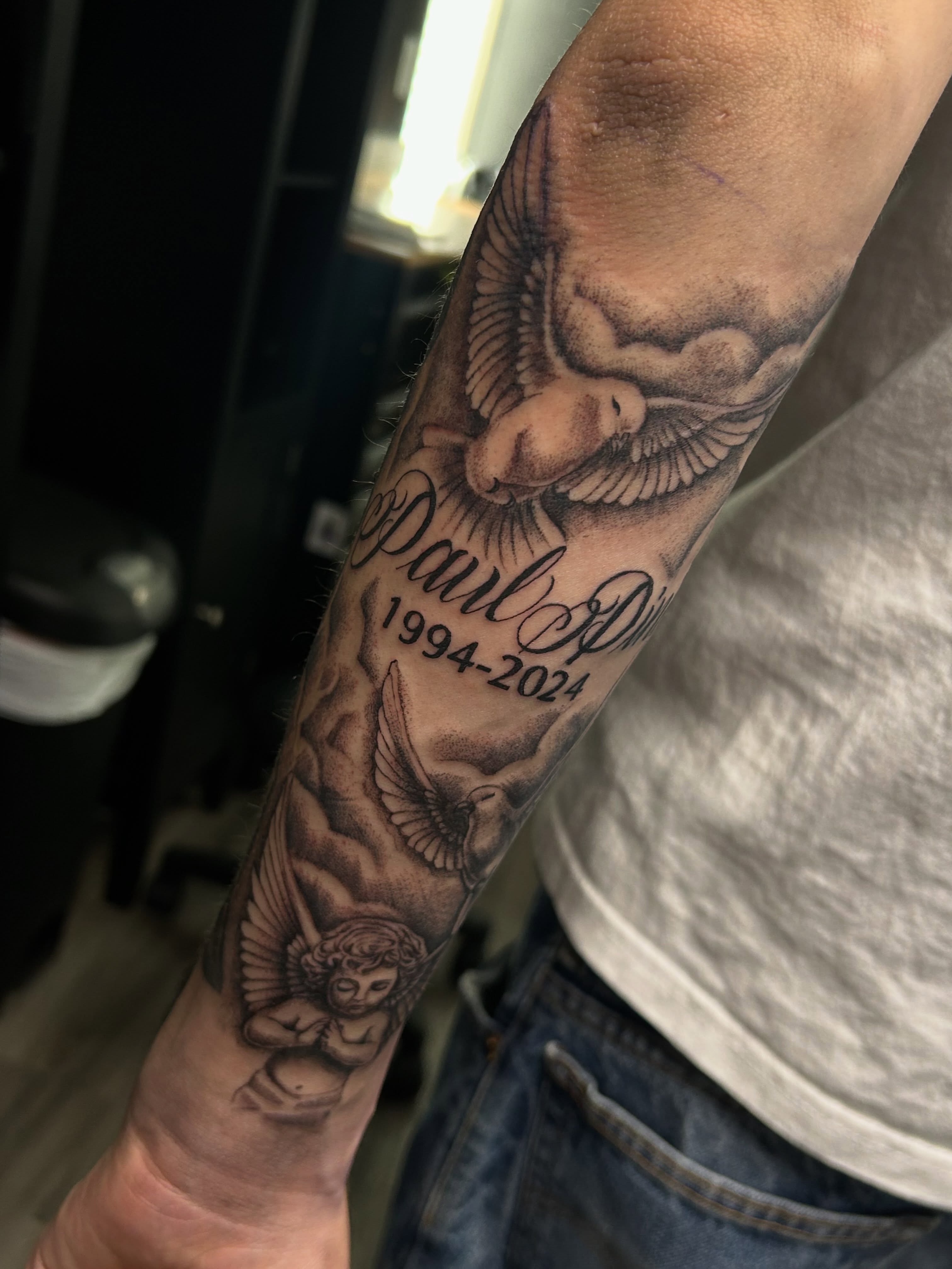 Angel with dove realism tattoo on the forearm by Ximena Favela