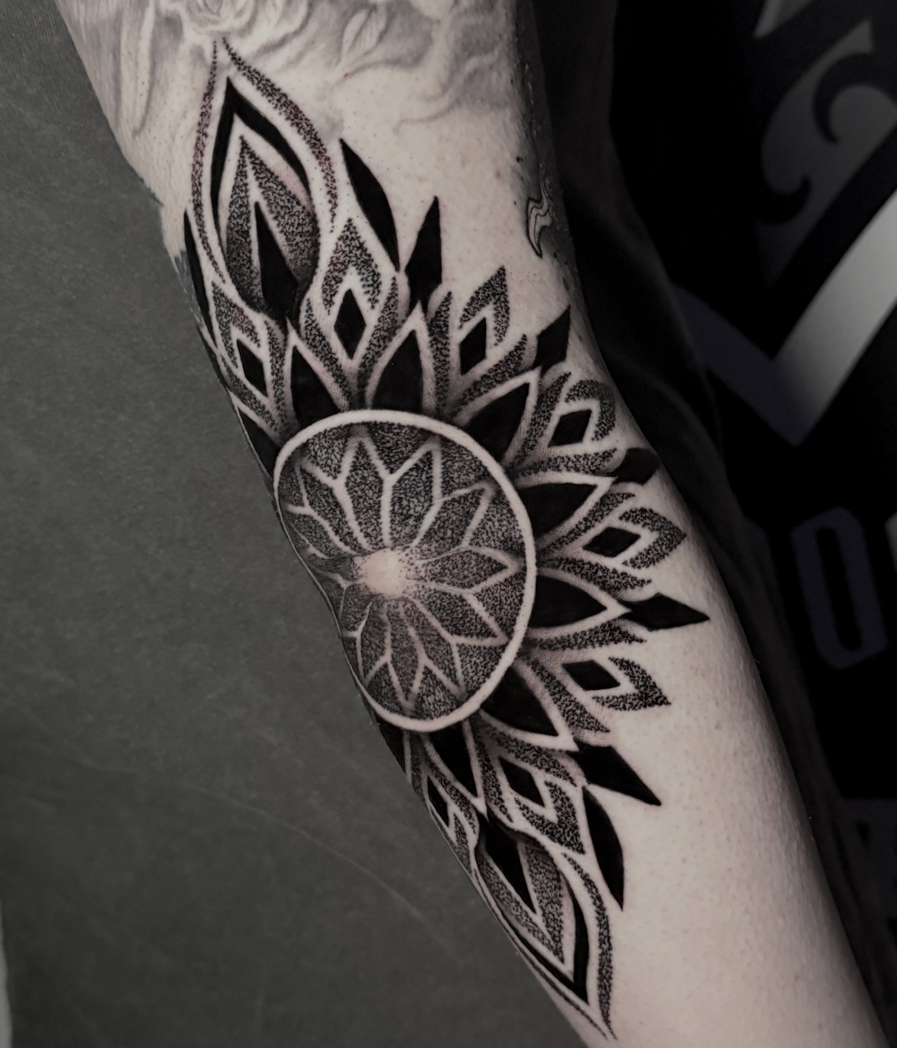 Lotus flower dotwork tattoo on the forearm by Clayton Smith (BEAR)