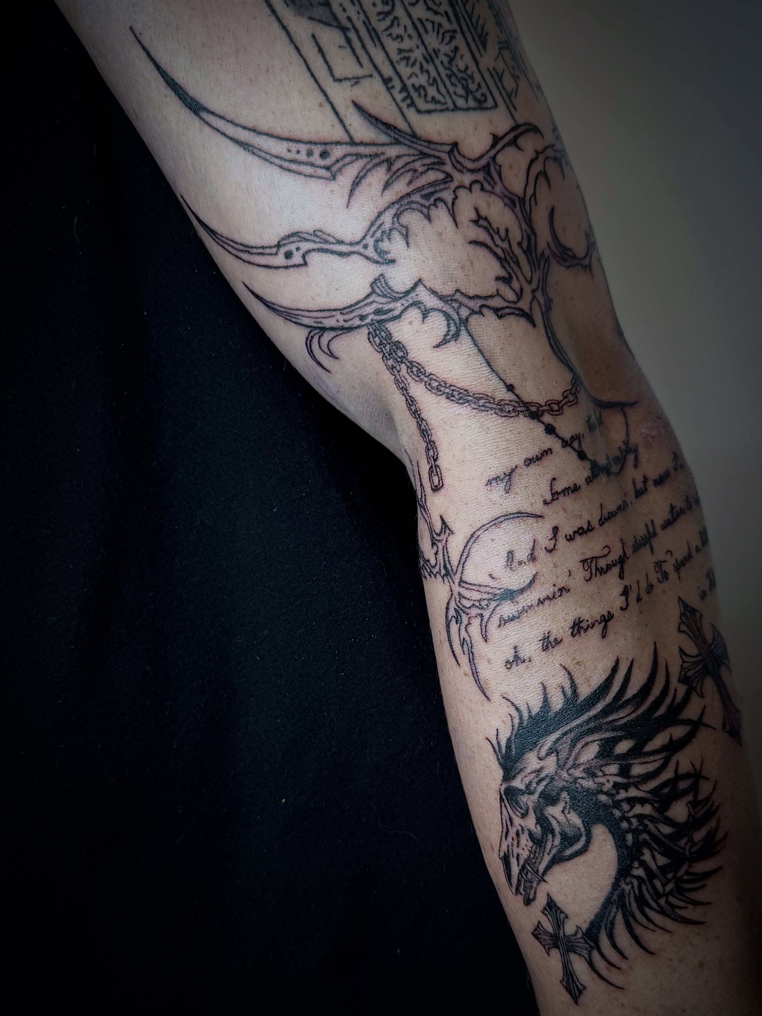 Dragon and cross black and grey tattoo on the forearm by dev