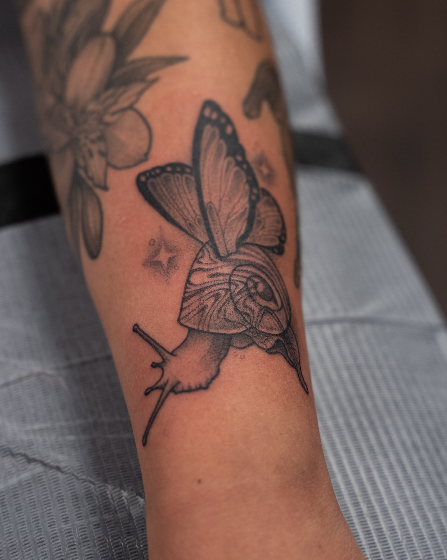 Butterfly dotwork tattoo on the forearm by Chris Estrada