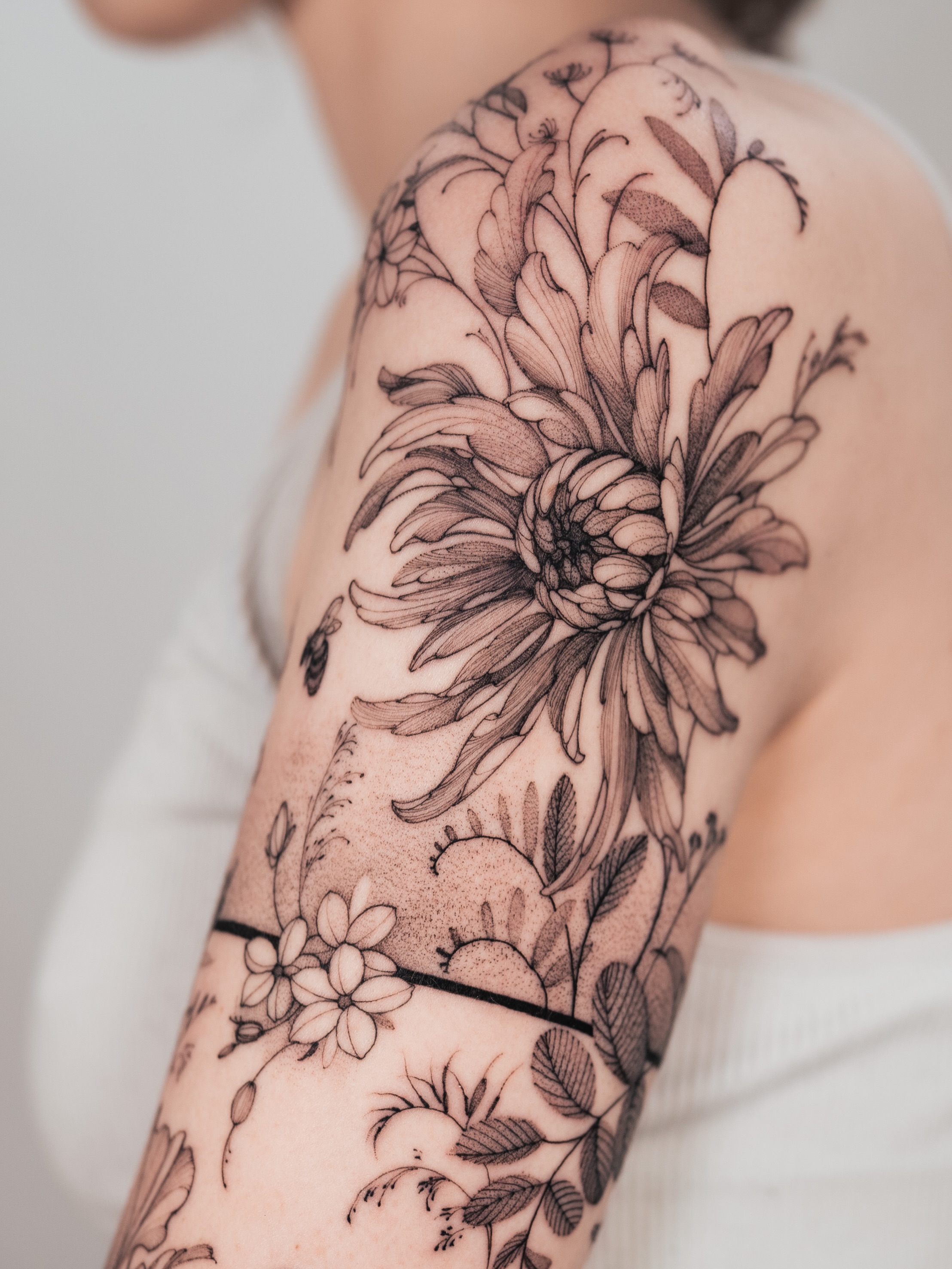 Chrysanthemum black and grey tattoo on the shoulder by Yuliia Babych tattoo AUSTIN