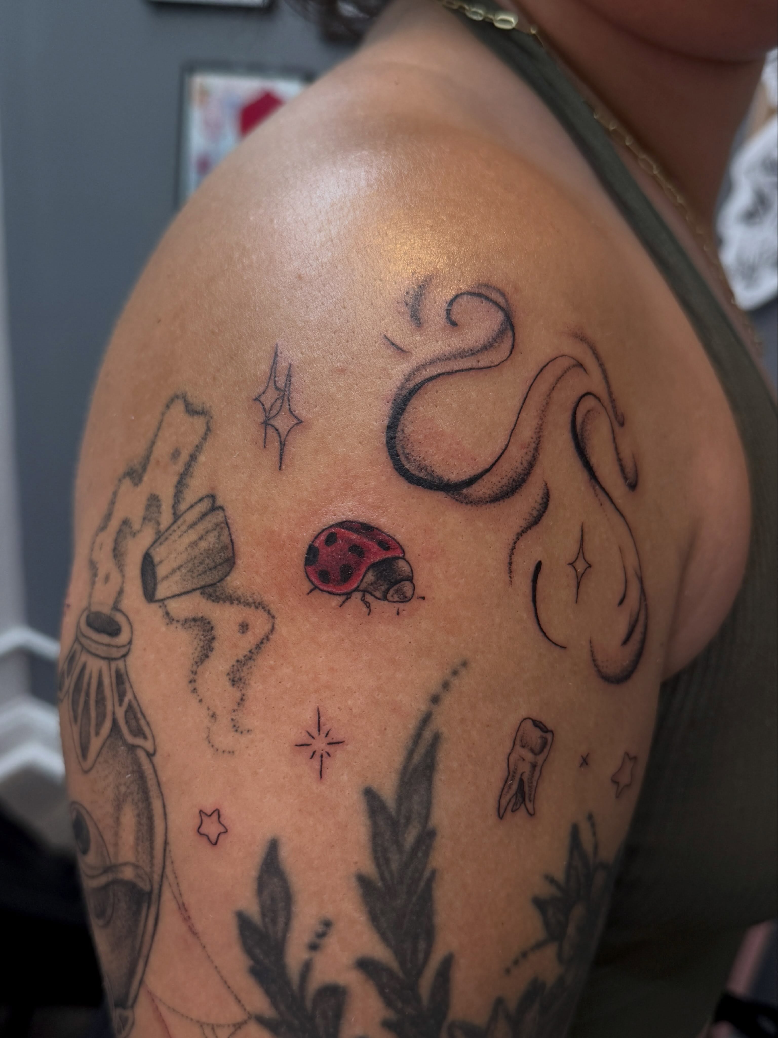 Ladybug and stars trash polka tattoo on the shoulder by Kamakana Pankiwska