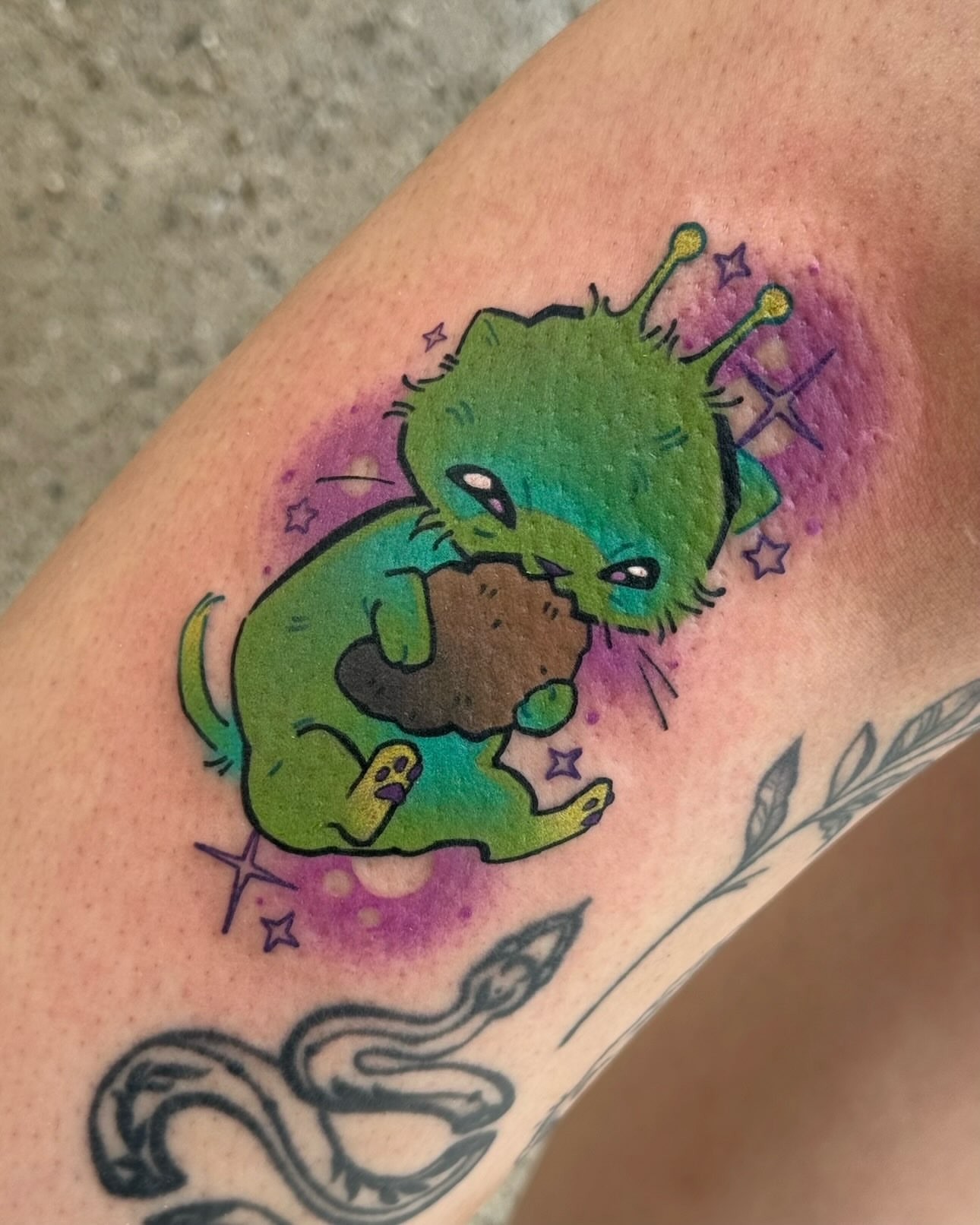 Alien cat new school tattoo on the forearm by Taylor Nicoll Chunn