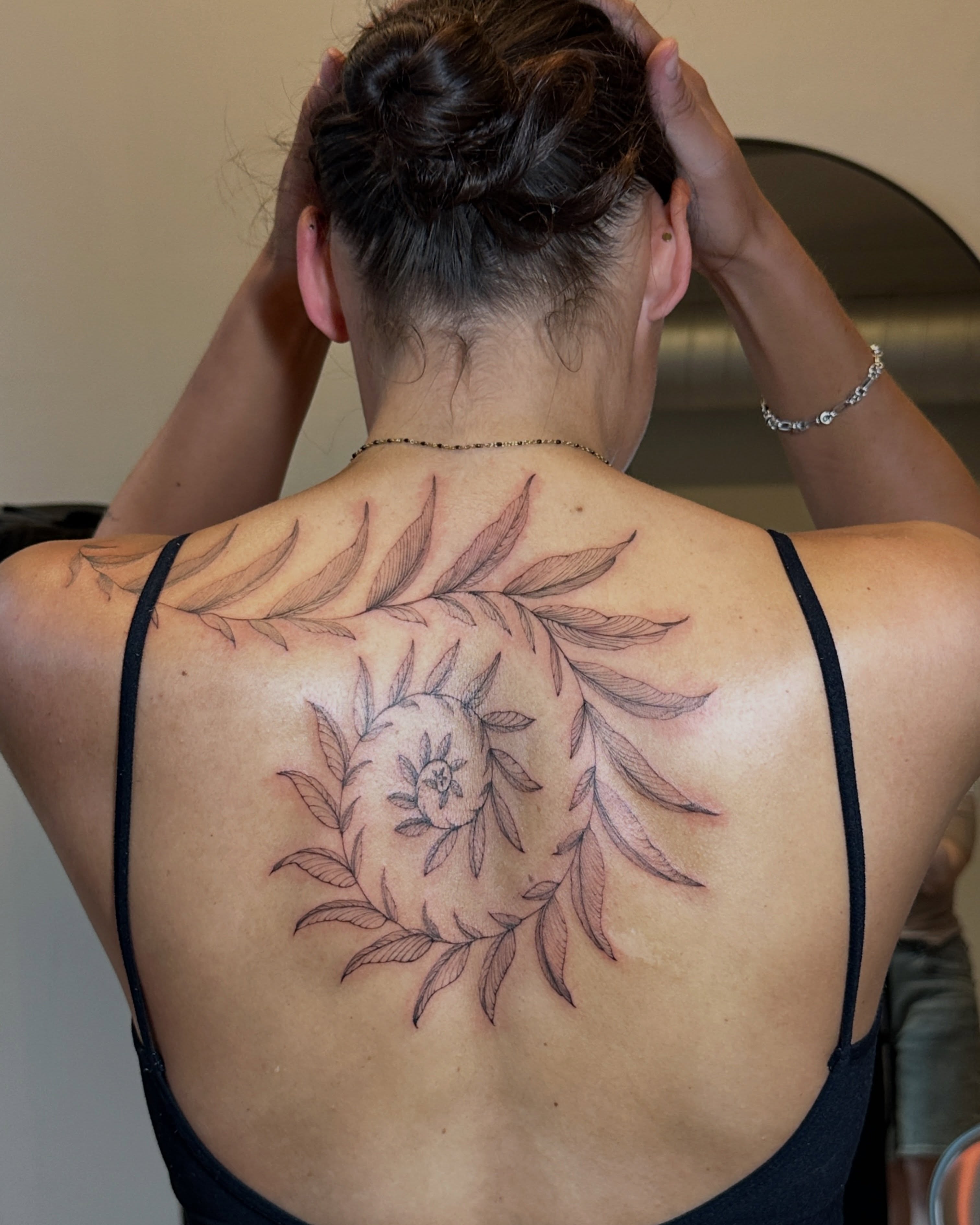 Peony and leaves black and grey tattoo on the back by Zalina Loriia