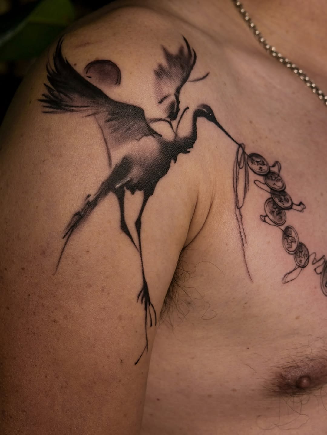 Crane with coins fine line tattoo on the shoulder by Jinz