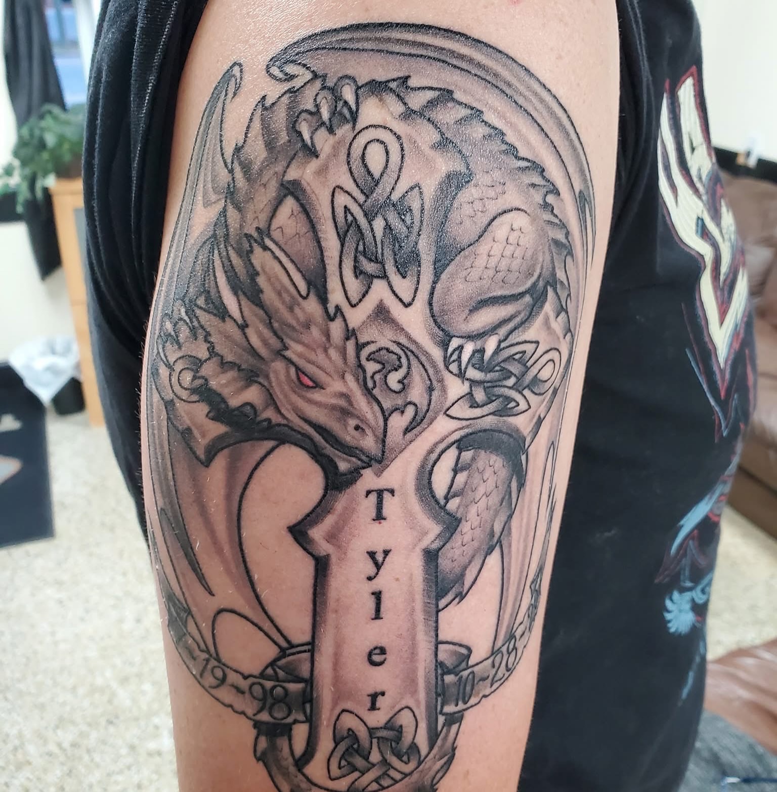 Dragon and cross realism tattoo on the forearm by Cameron Mills - Tattoo artist