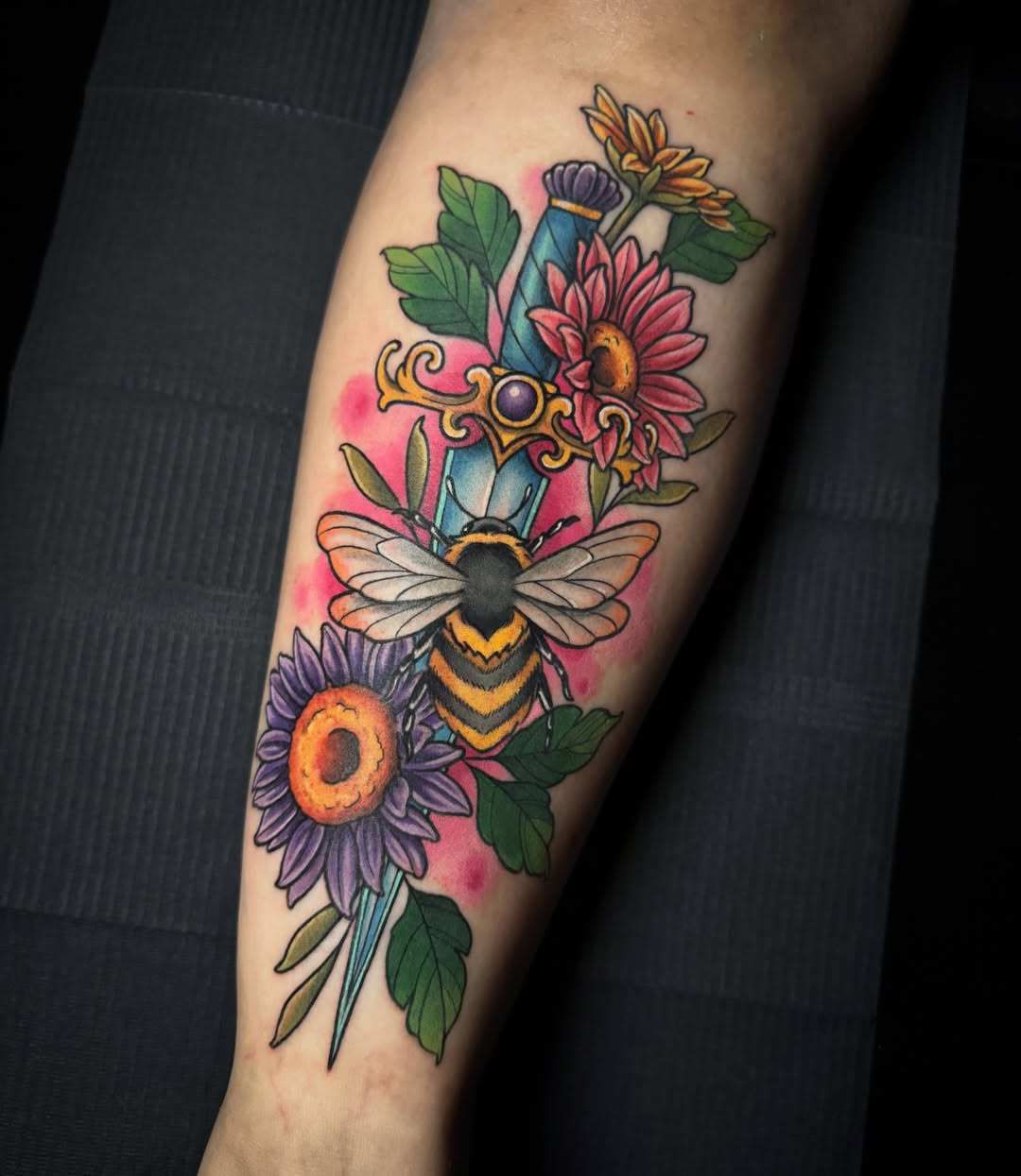 Flower arrangement with bee new school tattoo on the forearm by Dee Florian