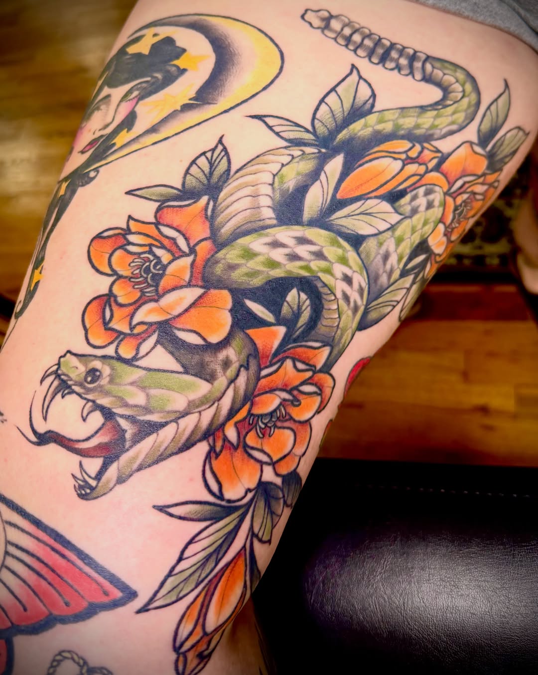 Snake and flowers American traditional tattoo on the thigh by Feliz Manzanedo, Prescott, Arizona
