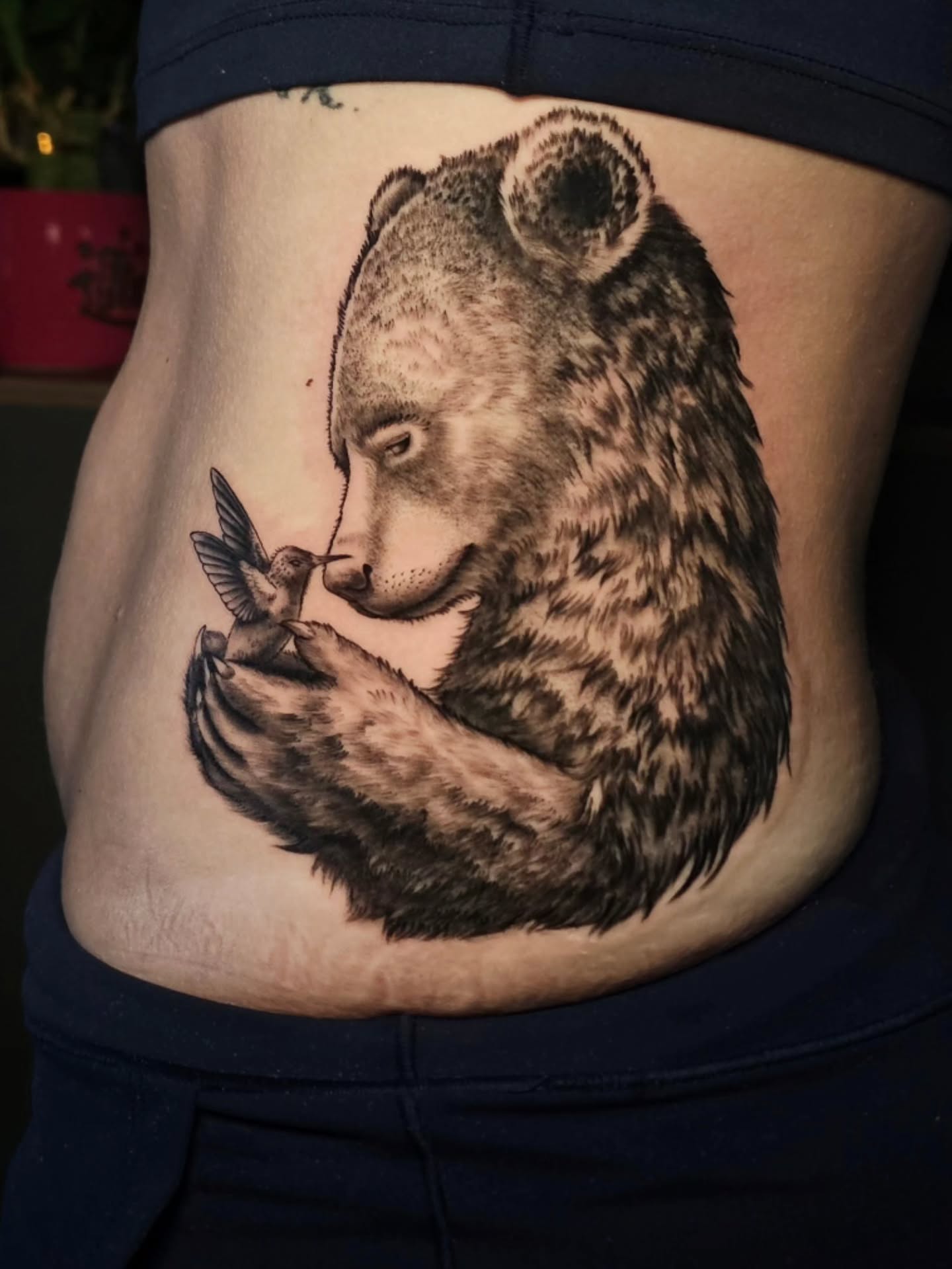 Bear and hummingbird realism tattoo on the ribs by Adriannah Esparza
