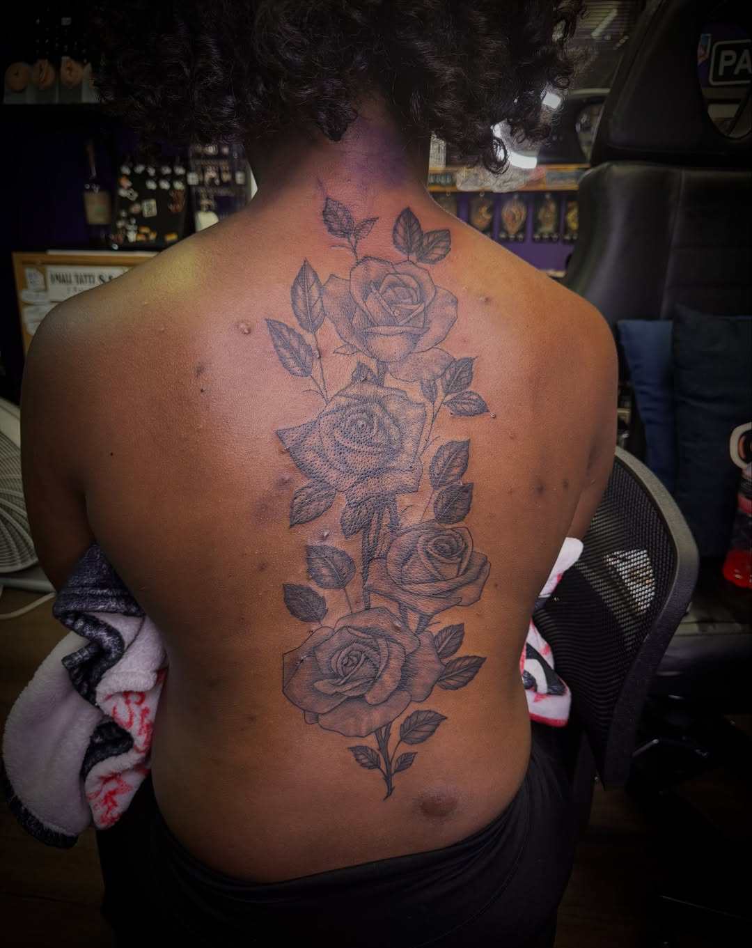 Roses black and grey tattoo on the back by Christian Goines, Memphis, Tennessee