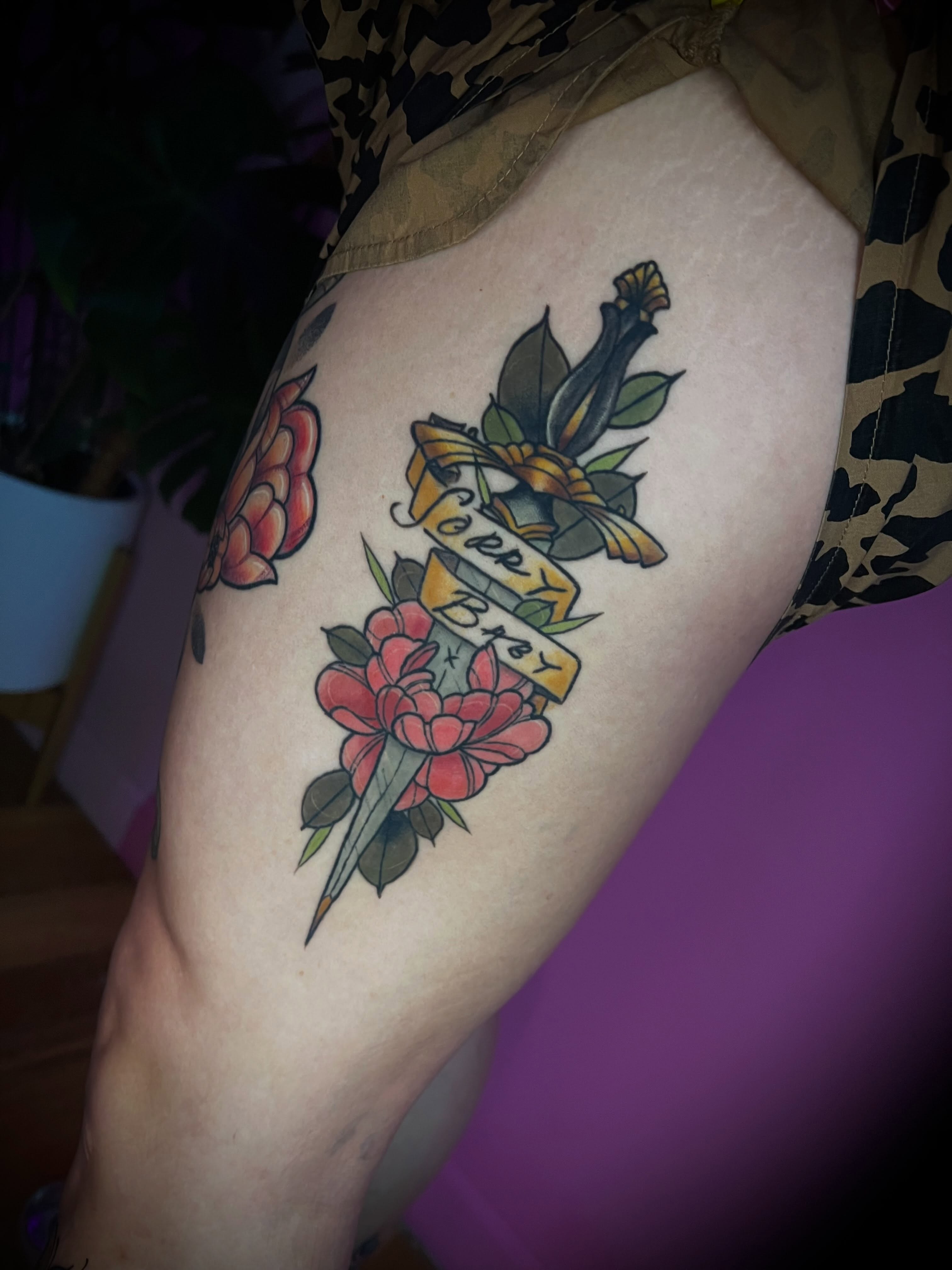 Floral bouquet American traditional tattoo on the thigh by jessica valentine