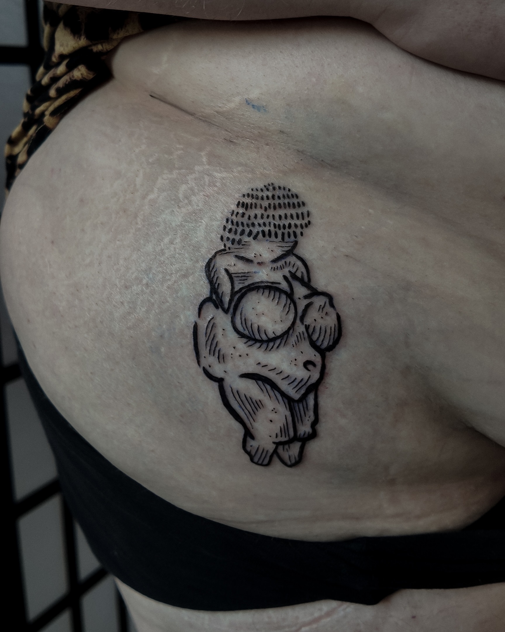 Ancient figurine dotwork tattoo on the thigh by Morgan Diann