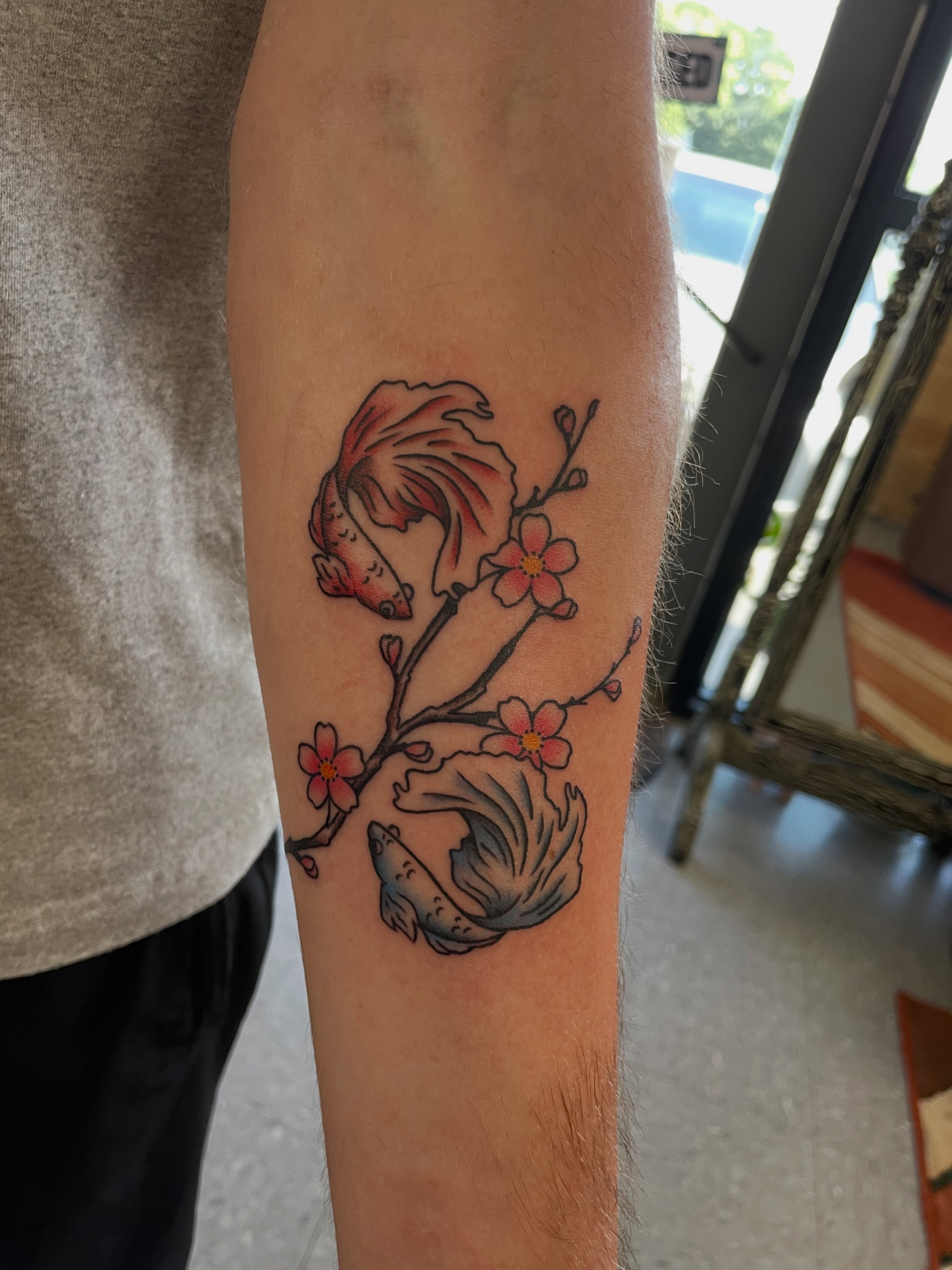 Koi fish and cherry blossoms japanese irezumi tattoo on the forearm by Mallory Moore