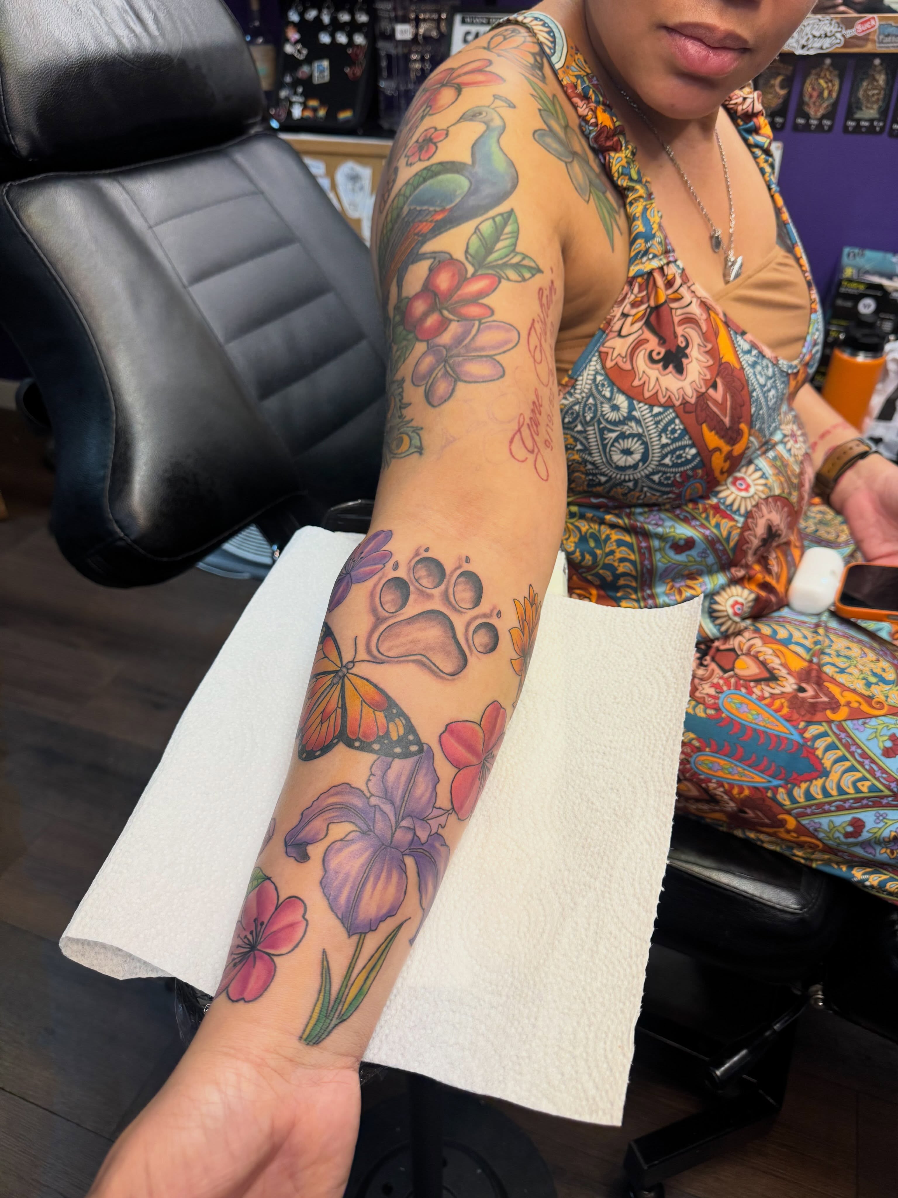 Floral and paw print American traditional tattoo on the forearm by Christian Goines, Memphis, Tennessee