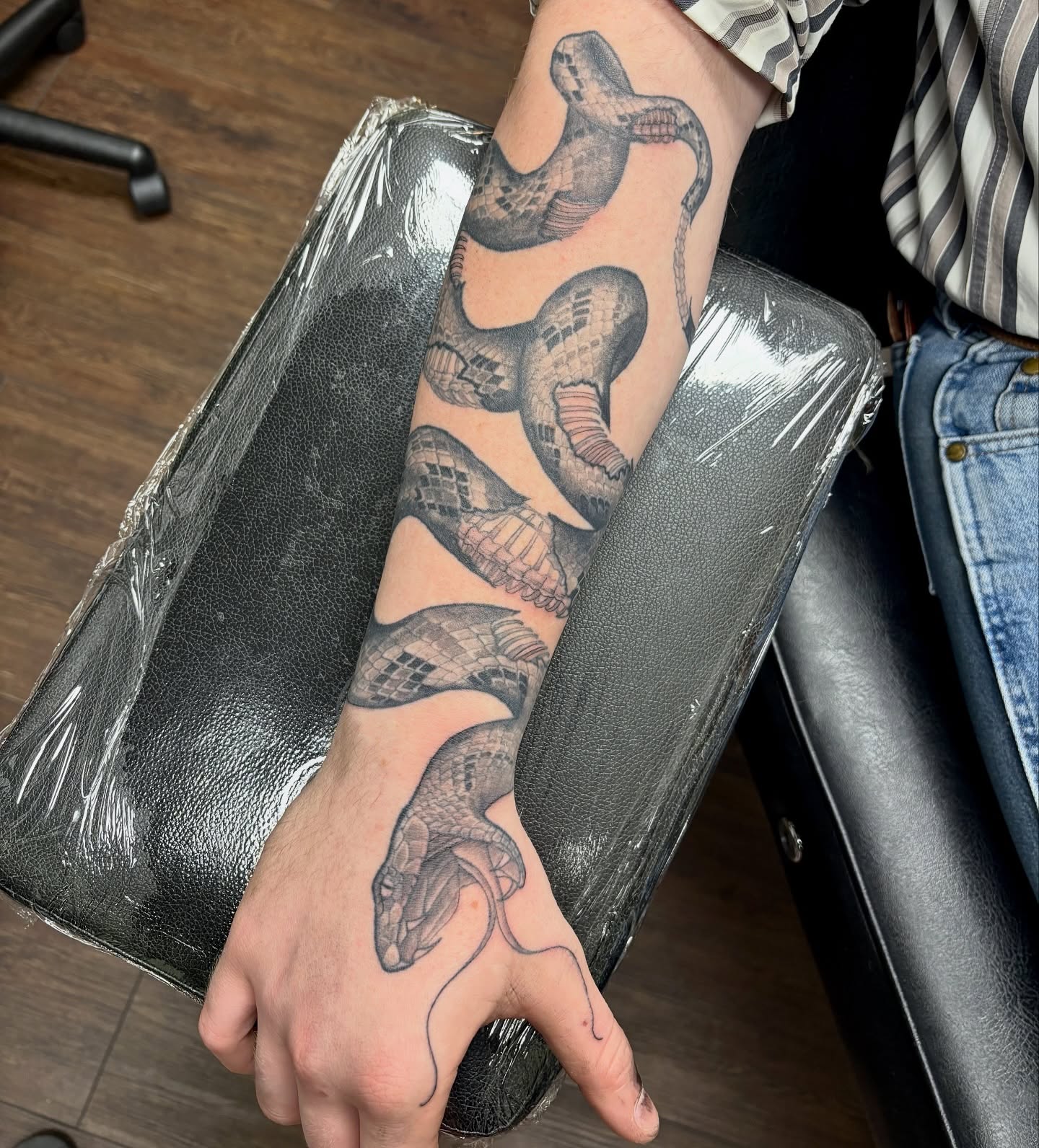 Snake black and grey tattoo on the forearm by sydney honn