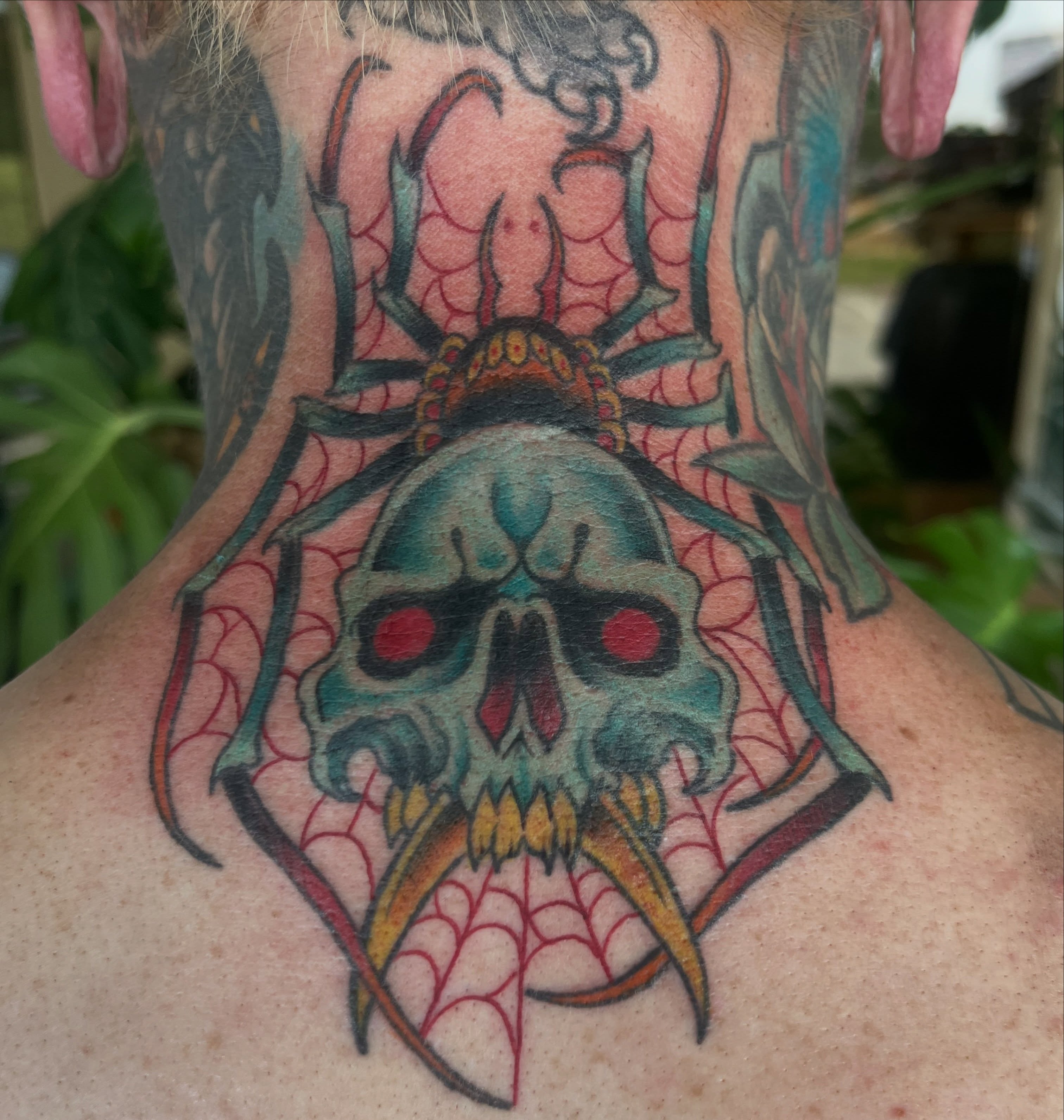 Skull with spiderweb neo-traditional tattoo on the neck by Tattoos and art by Ghost Shipe