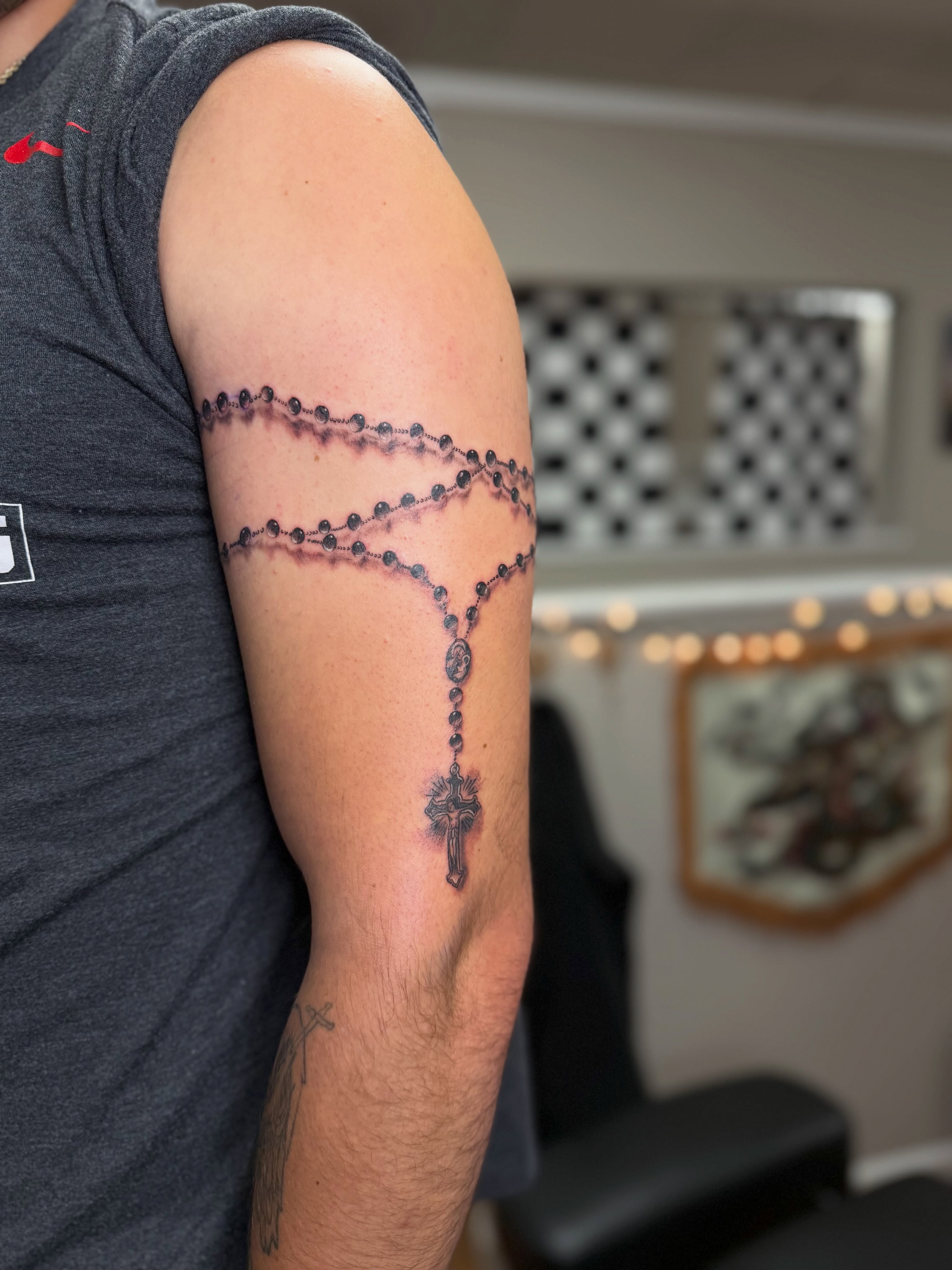 Rosary black and grey tattoo on the forearm by Skylar Sheeley