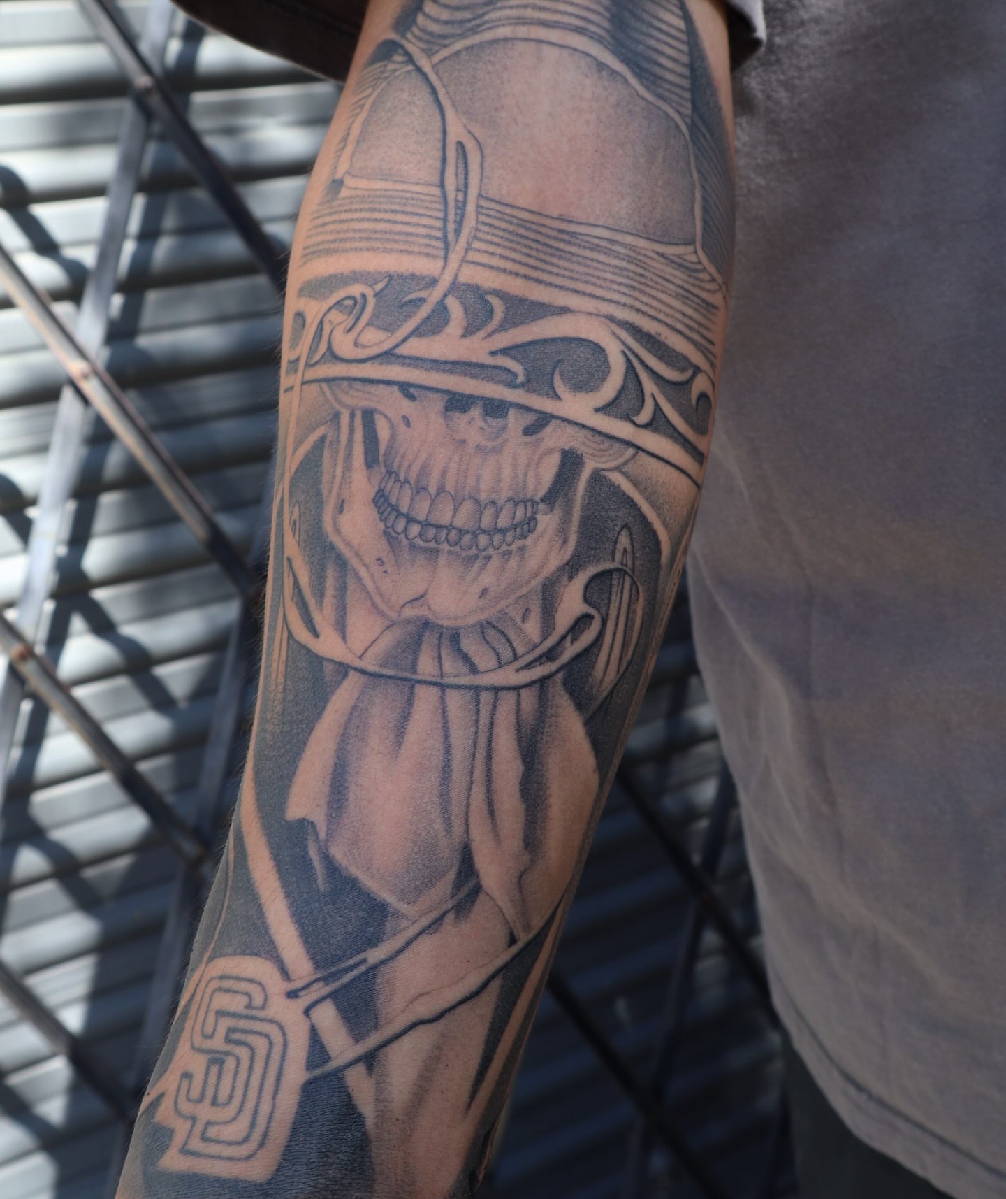 Skull wearing cowboy hat realism tattoo on the forearm by San Diego Tattoo Artist