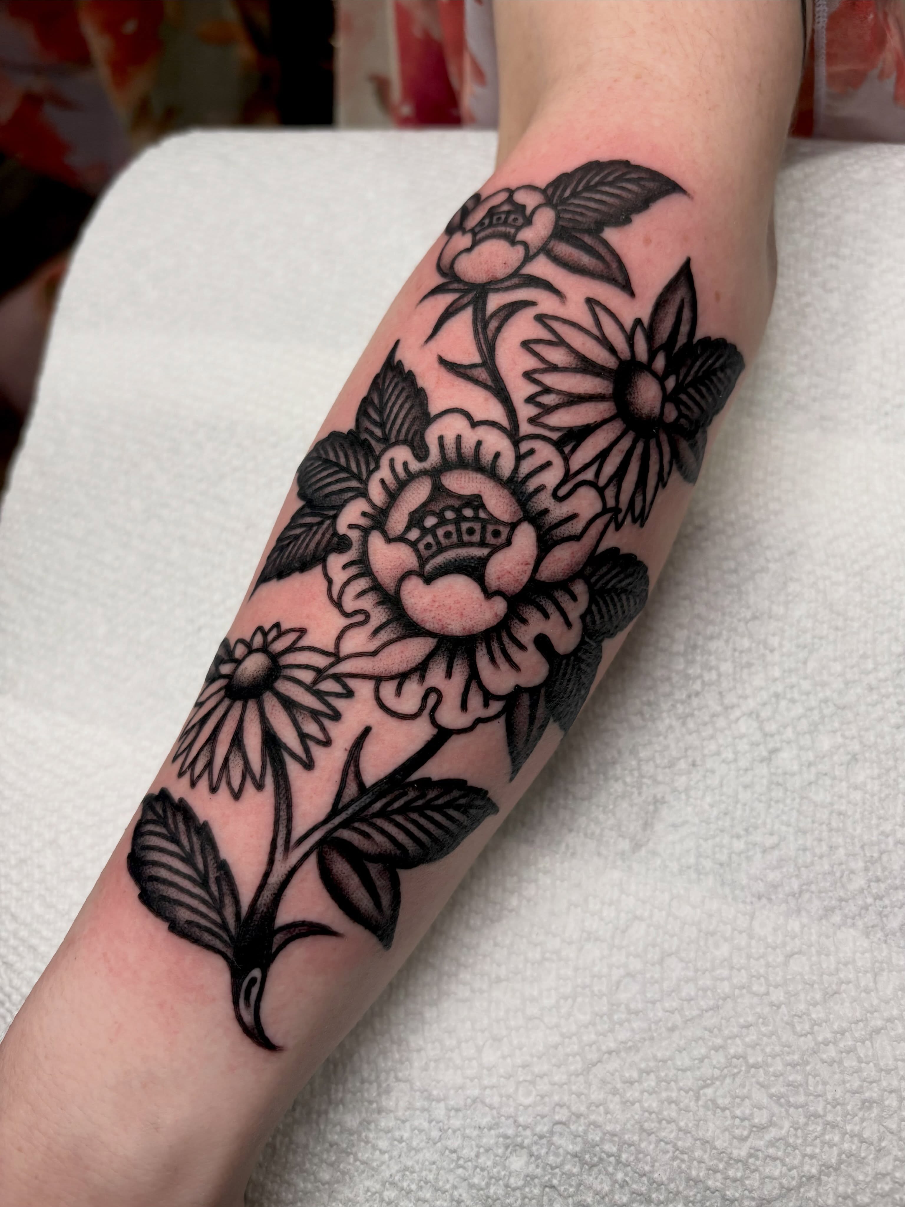 Floral arrangement black and grey tattoo on the forearm by sally ★ lee