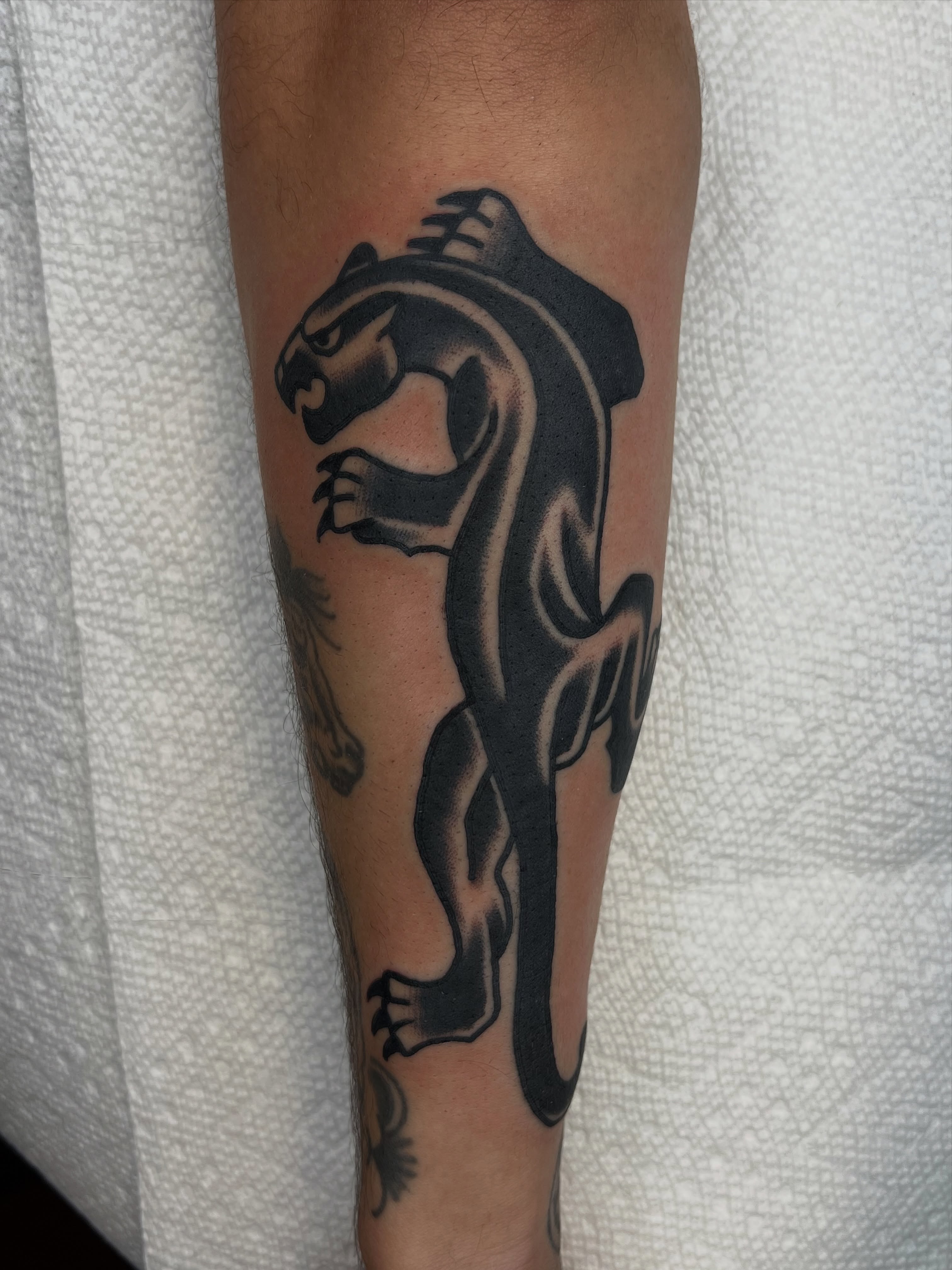 Panther black and grey tattoo on the forearm by Nestor Zelaya