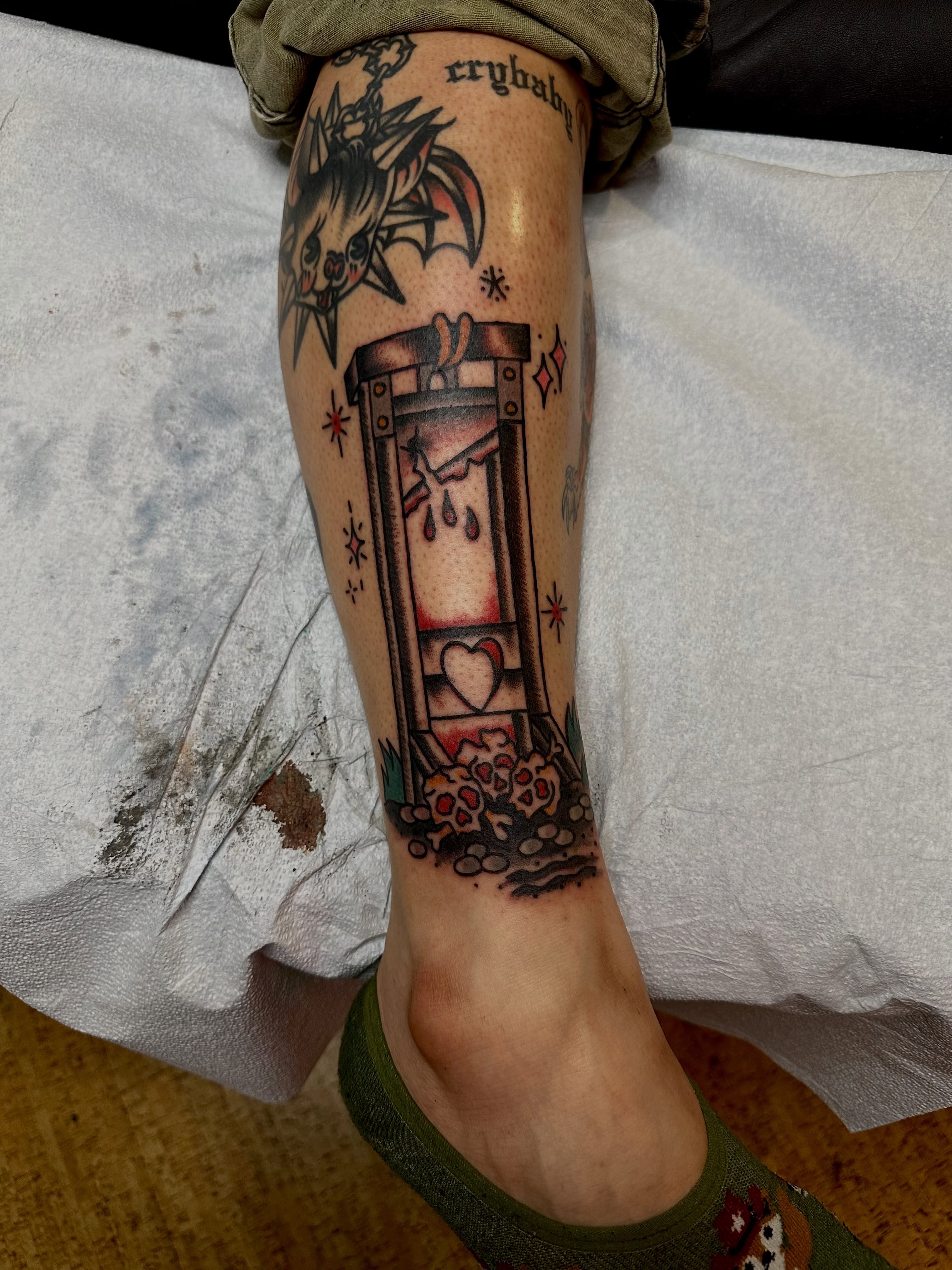 Hourglass with heart neo-traditional tattoo on the calf by teddy, Portland, Oregon