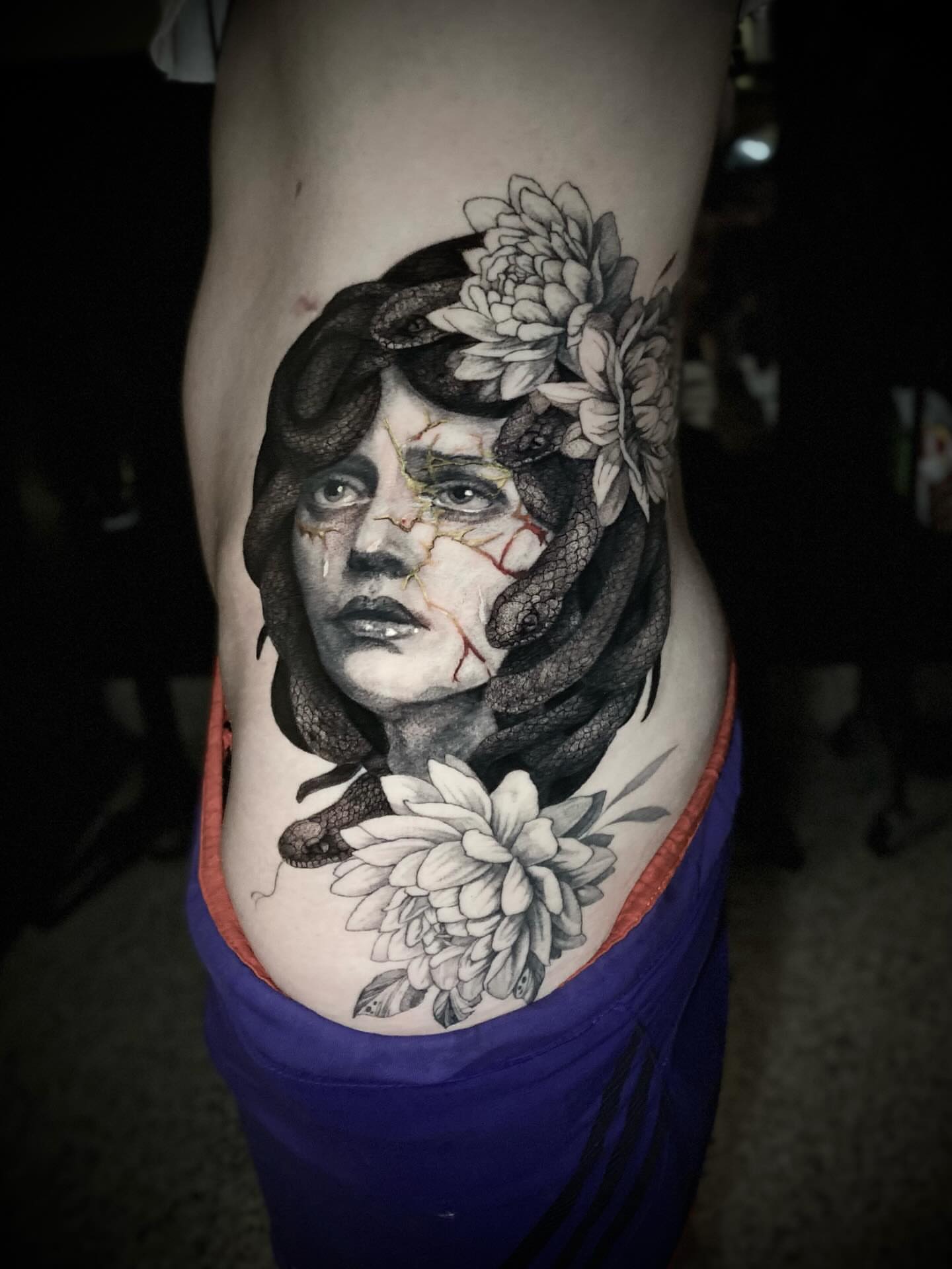 Woman with flowers realism tattoo on the thigh by Olivia Scott - Kansas Tattoo Artist