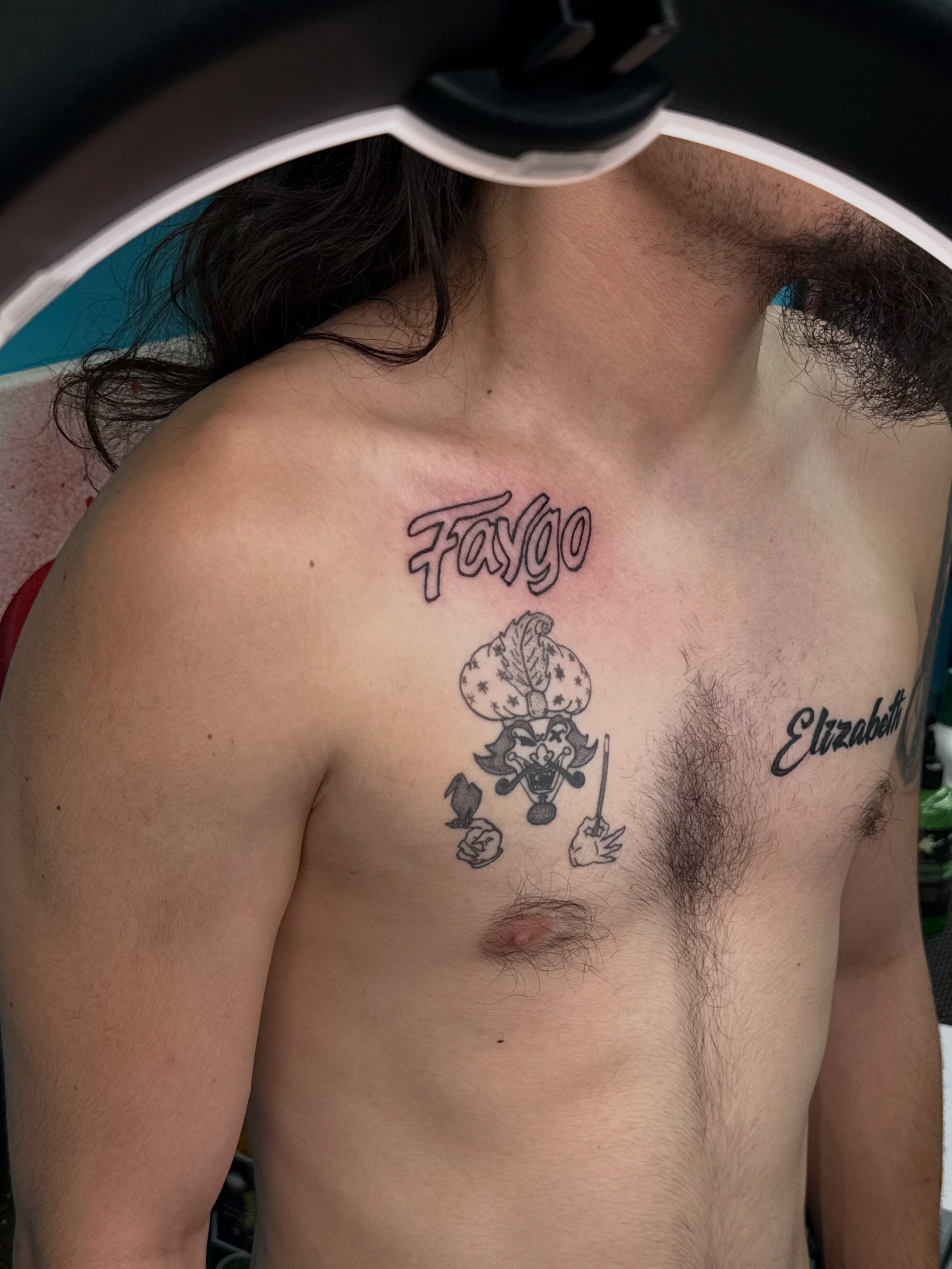 Fargo lettering script tattoo on the chest by ⠀Greave