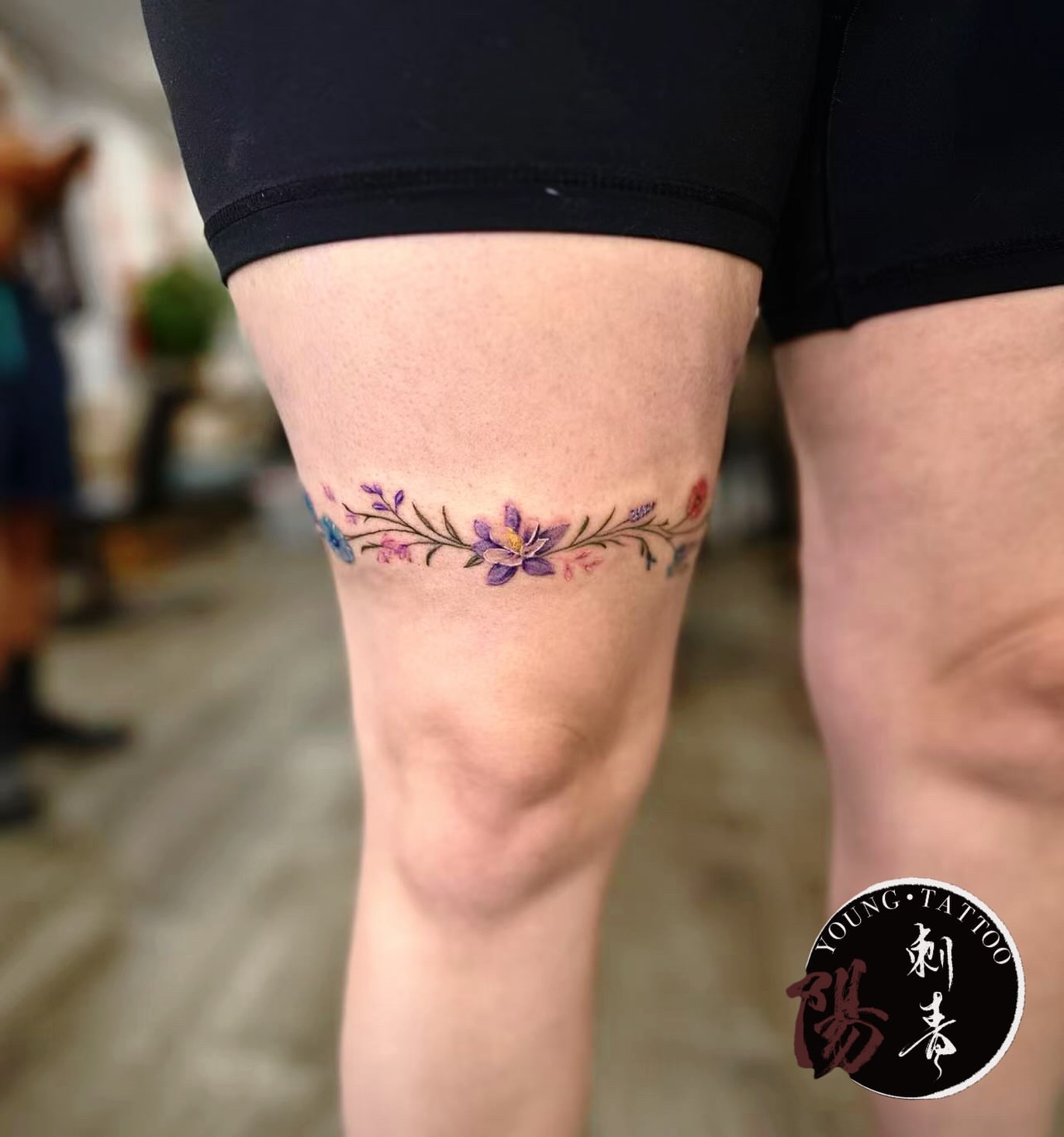 Floral vine watercolor tattoo on the calf by Ying