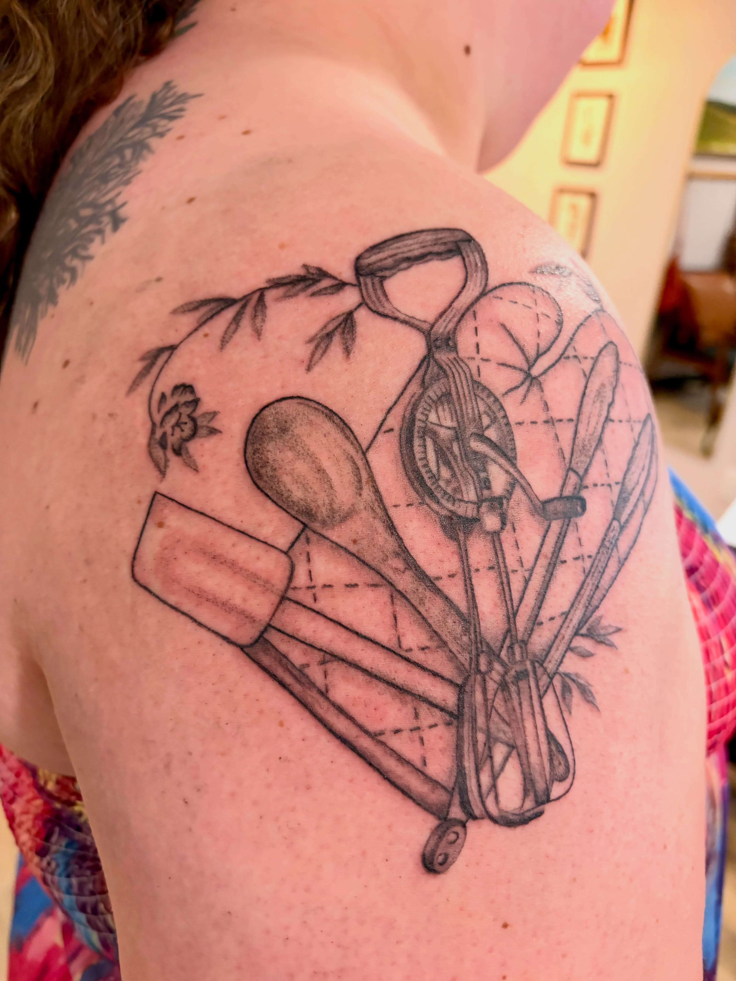 Cooking utensils black and grey tattoo on the shoulder by Emily, Monticello, Iowa