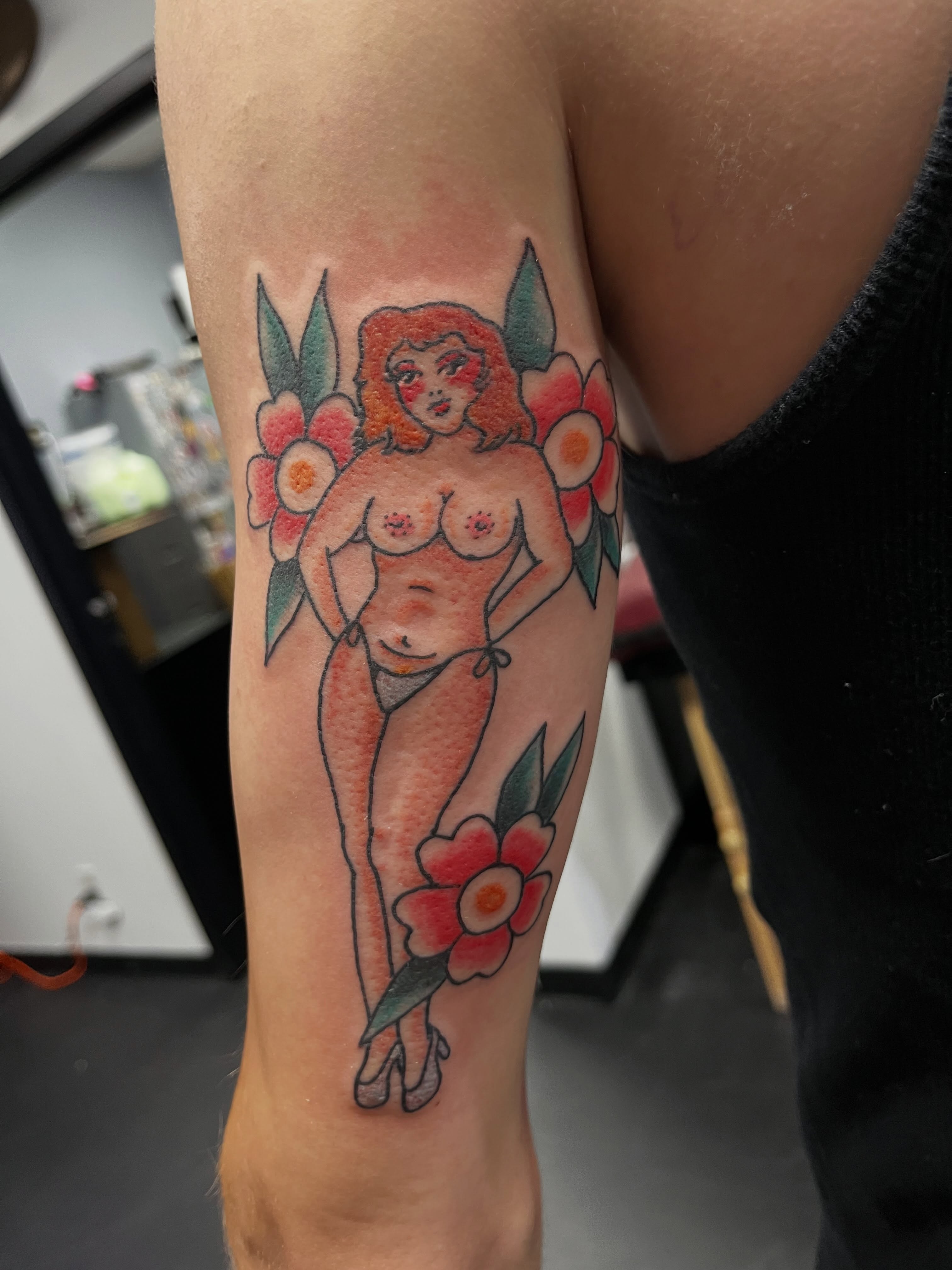 Nude woman with flowers new school tattoo on the forearm by CRAIG B⛓️ Cincinnati Tattoo Artist