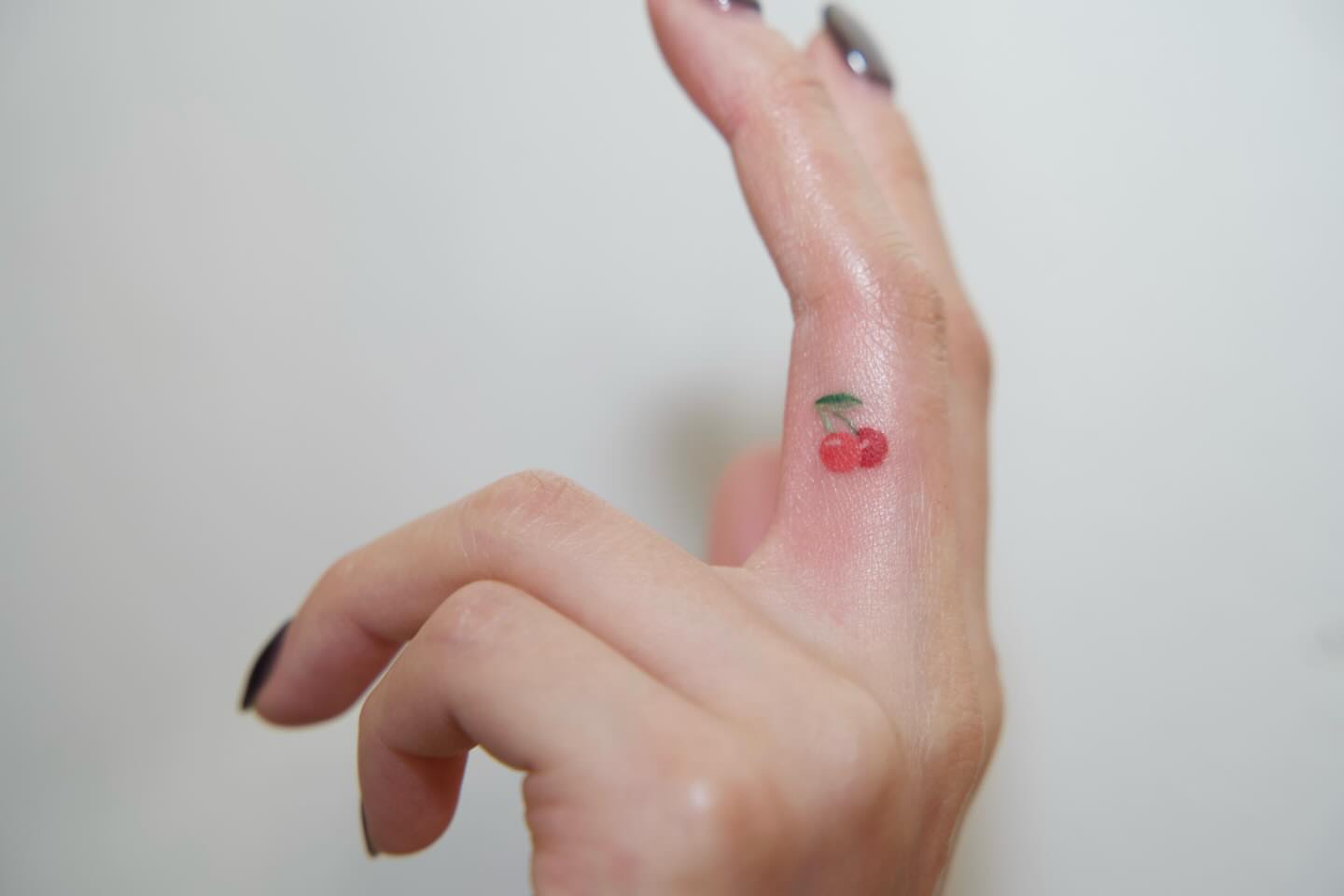 Cherry dotwork tattoo on the hand by Tomato