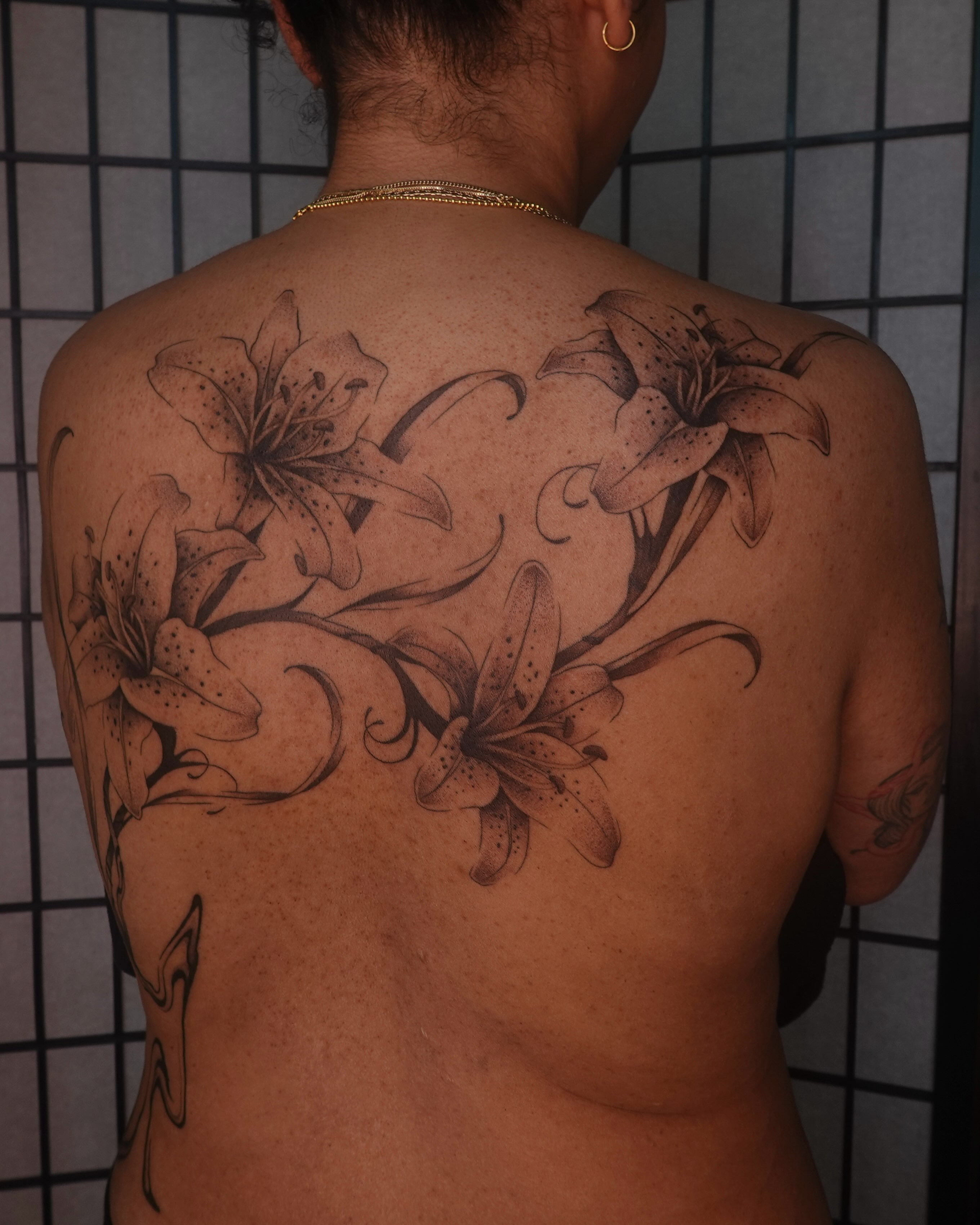 Lilies black and grey tattoo on the back by jun