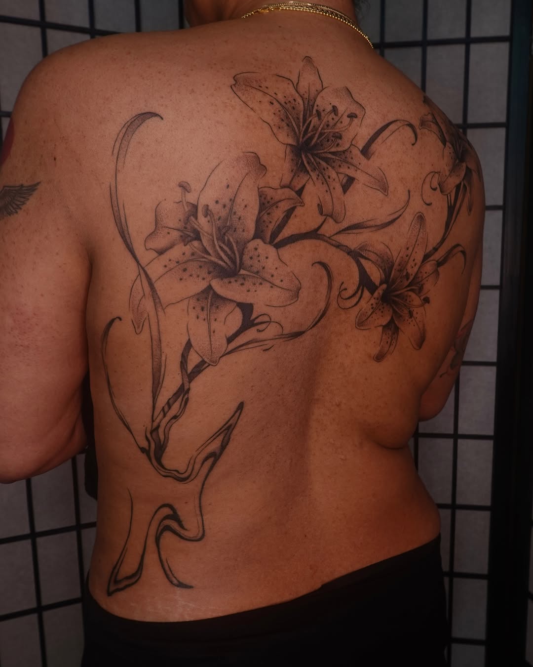 Lilies black and grey tattoo on the back by jun