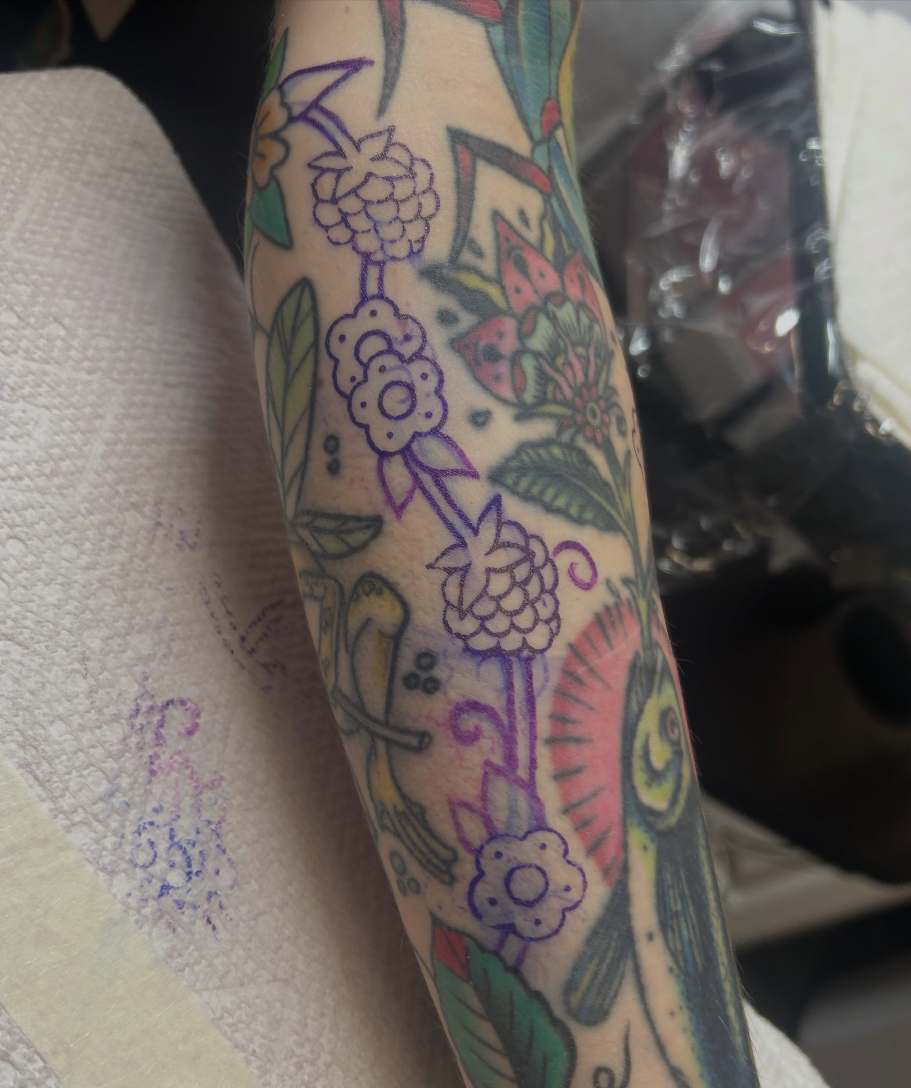Berry and floral bouquet American traditional tattoo on the forearm by Kelsey Lyons