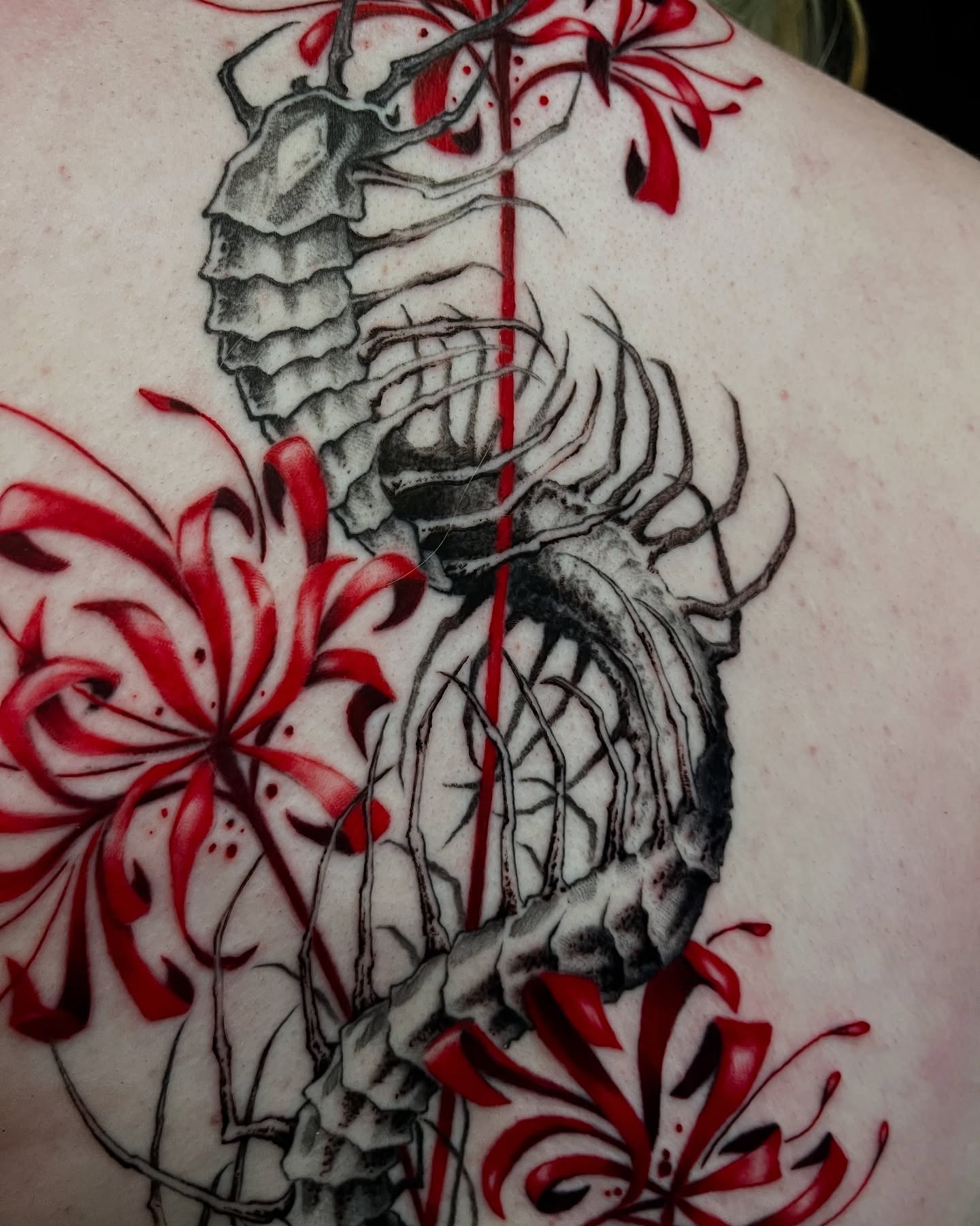 Scorpion and flowers realism tattoo on the back by Cameron Jenkins