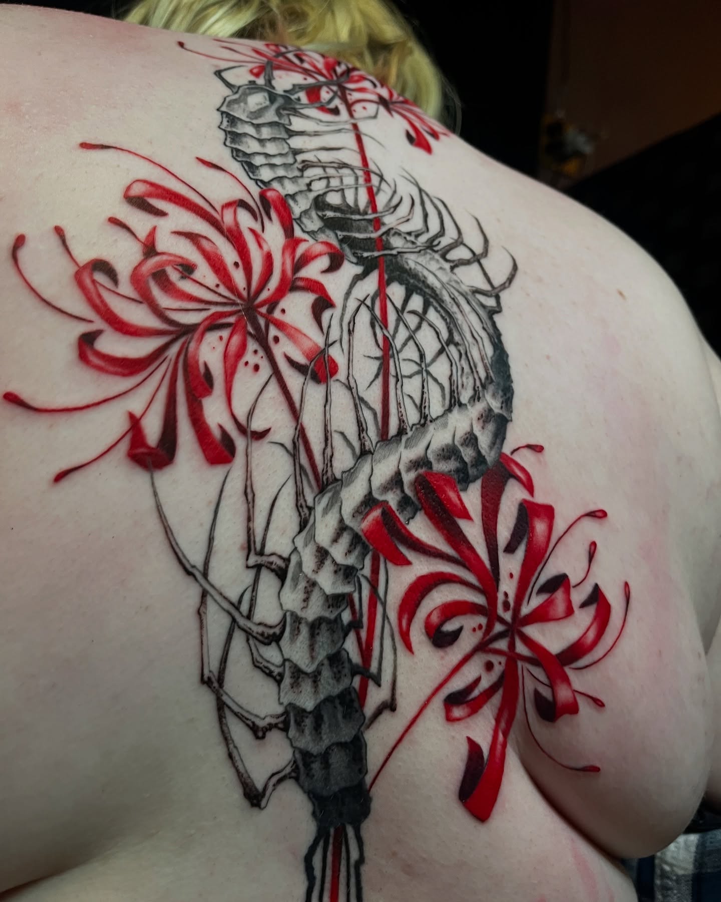 Insect and flowers realism tattoo on the shoulder by Cameron Jenkins