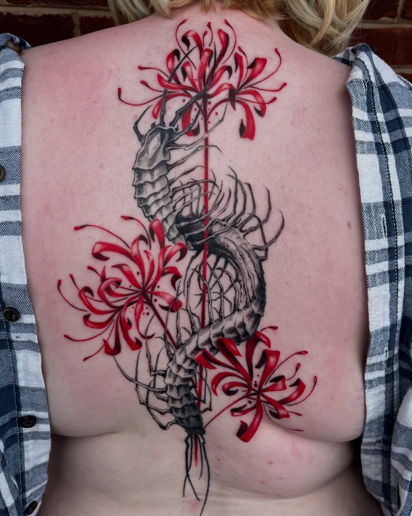 Seahorse and flowers realism tattoo on the back by Cameron Jenkins